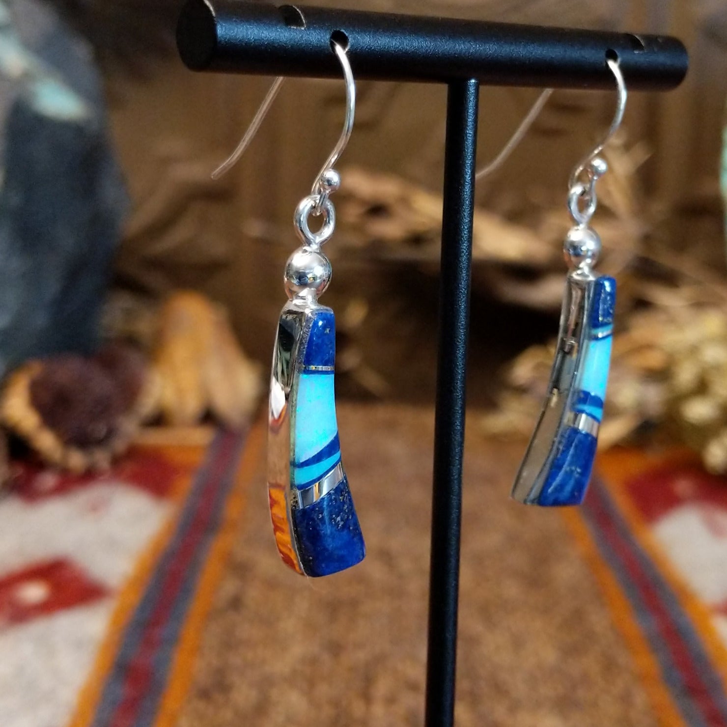 Flowing jewelry set with matching necklace, earrings, and cuff featuring lapis and manmade opal inlays.