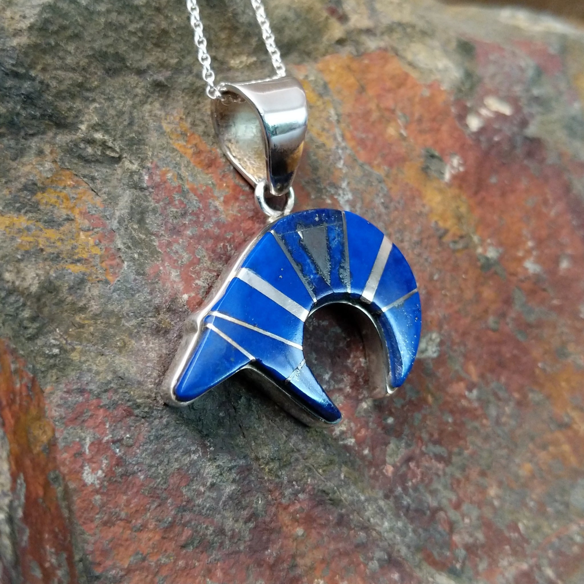 Handcrafted sterling silver lapis spirit bear pendant by T.G., featuring a traditional Navajo bear design; side view.