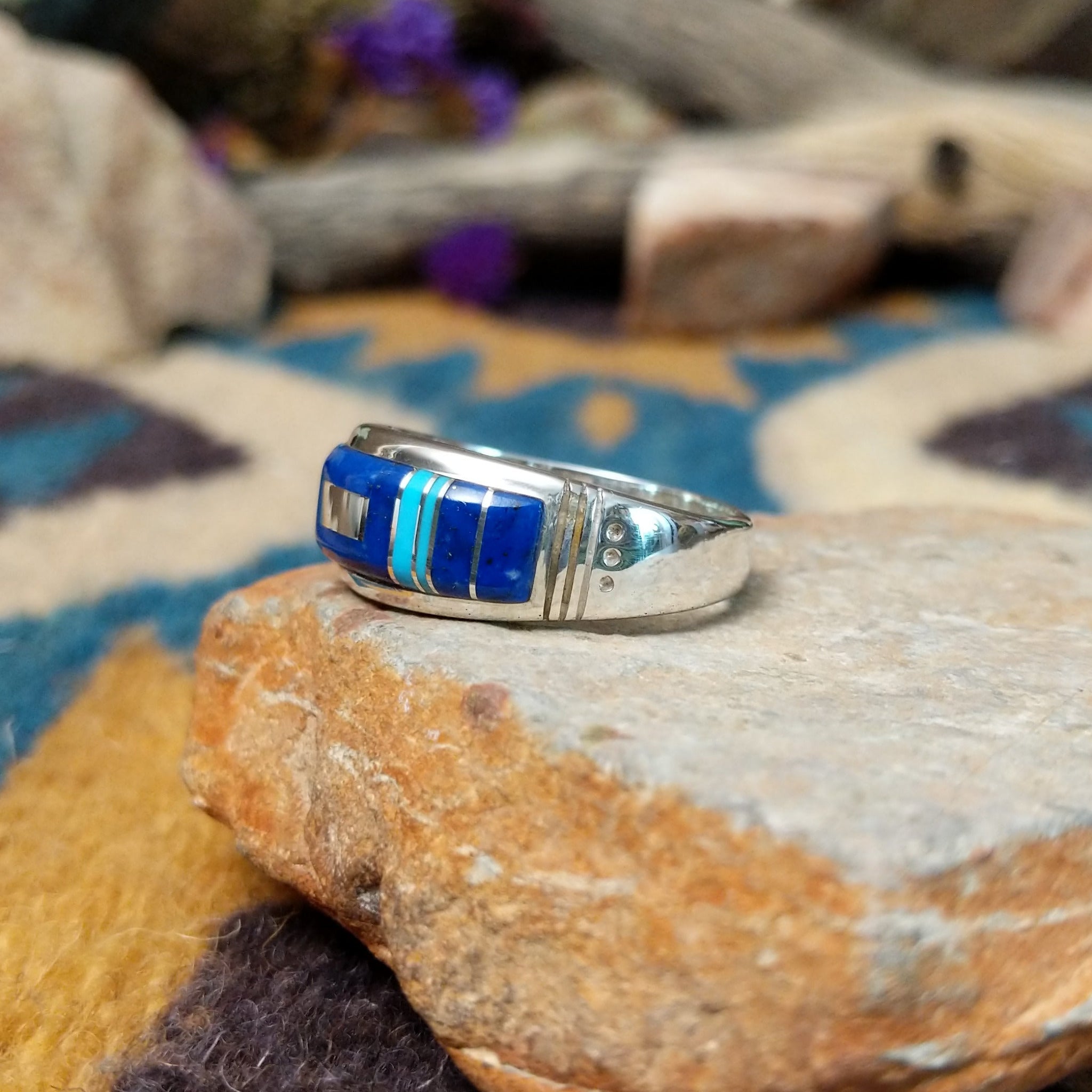 Sterling silver Navajo inlay ring with Lapis Lazuli, Turquoise, and geometric accents; side view.