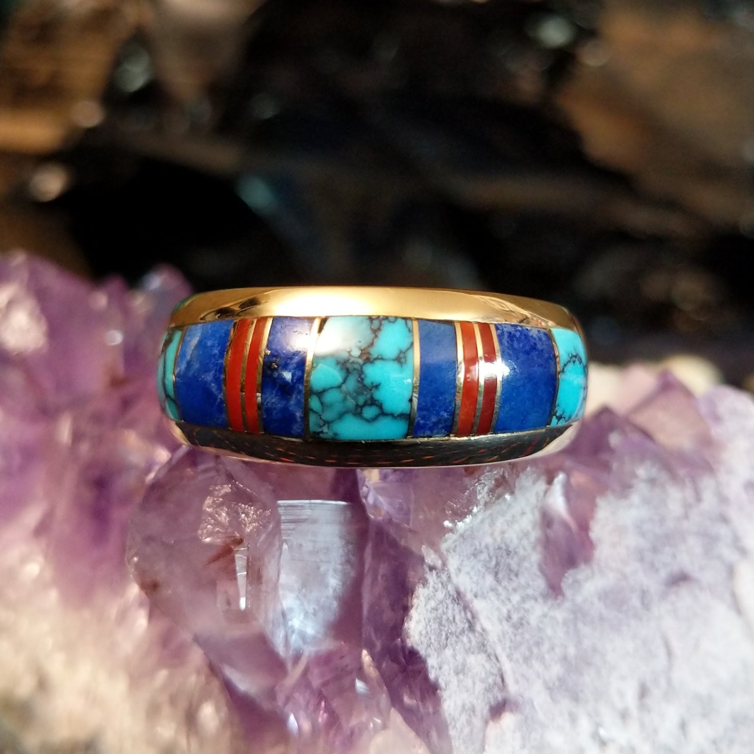 Navajo-crafted gold ring featuring inlay work in turquoise, lapis lazuli, and red coral.