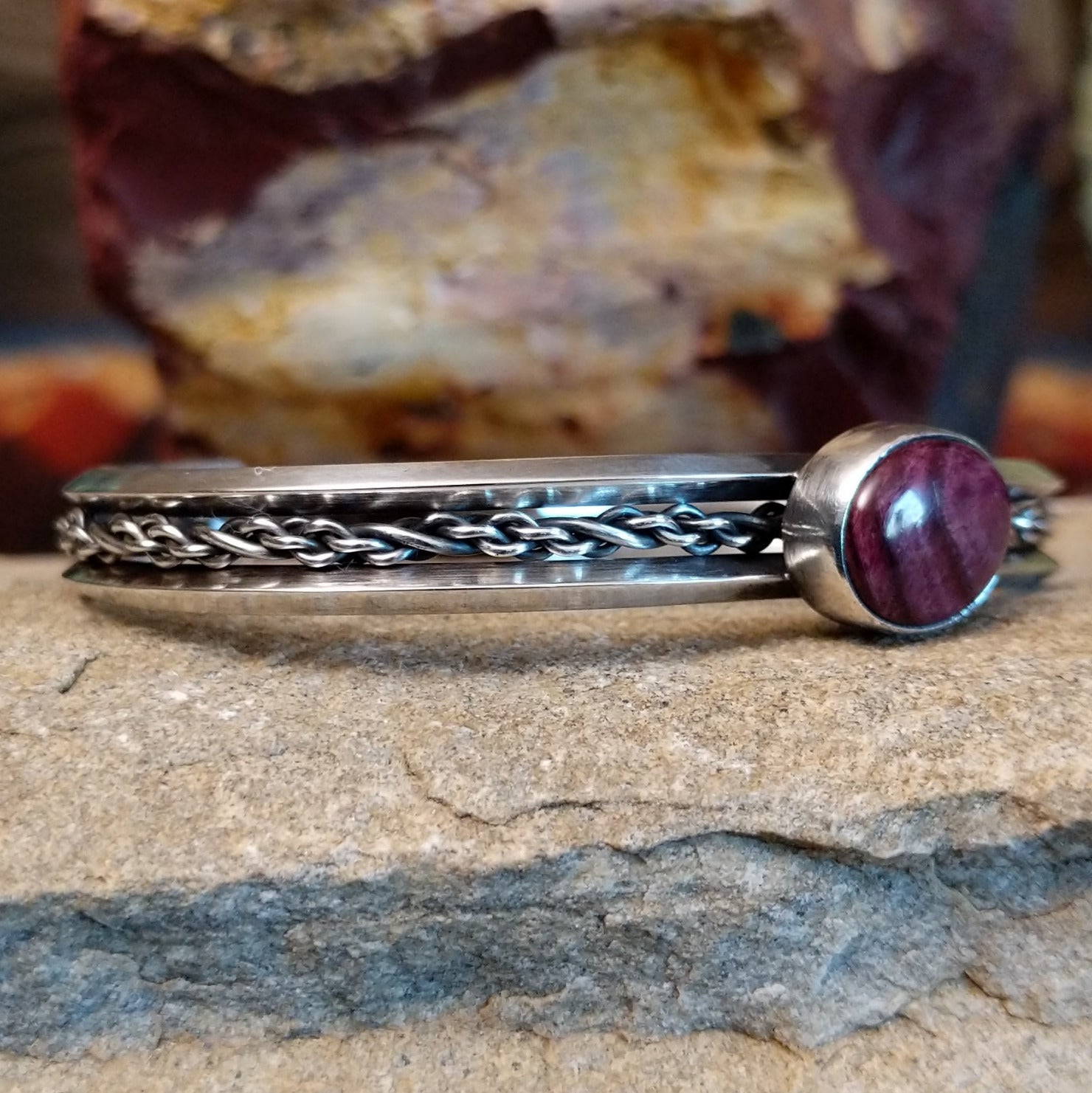 Navajo cuff features a polished purple spiny oyster shell centerpiece, framed by intricate sterling silver chain work.
