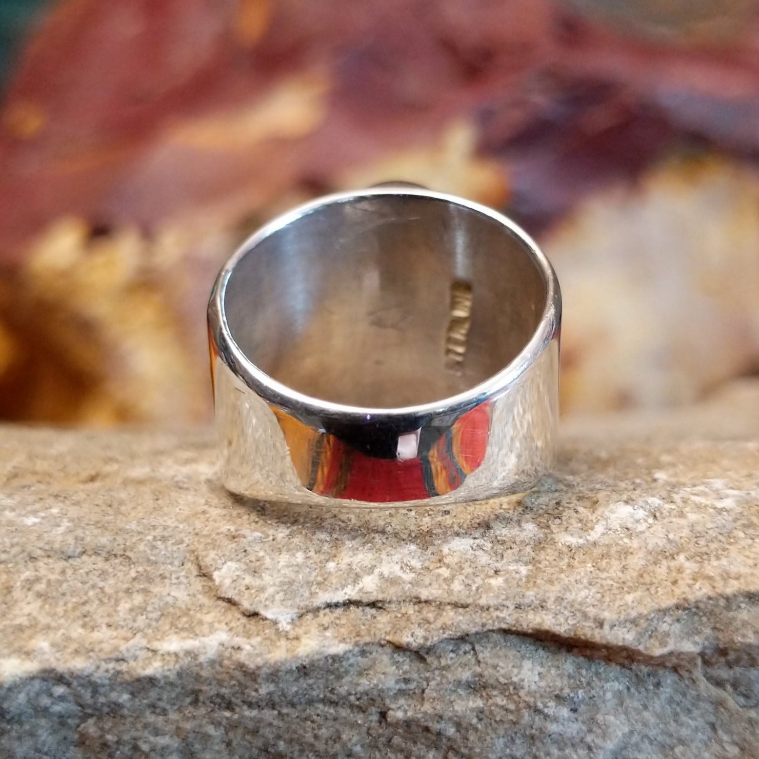 Polished, tapered sterling silver band.