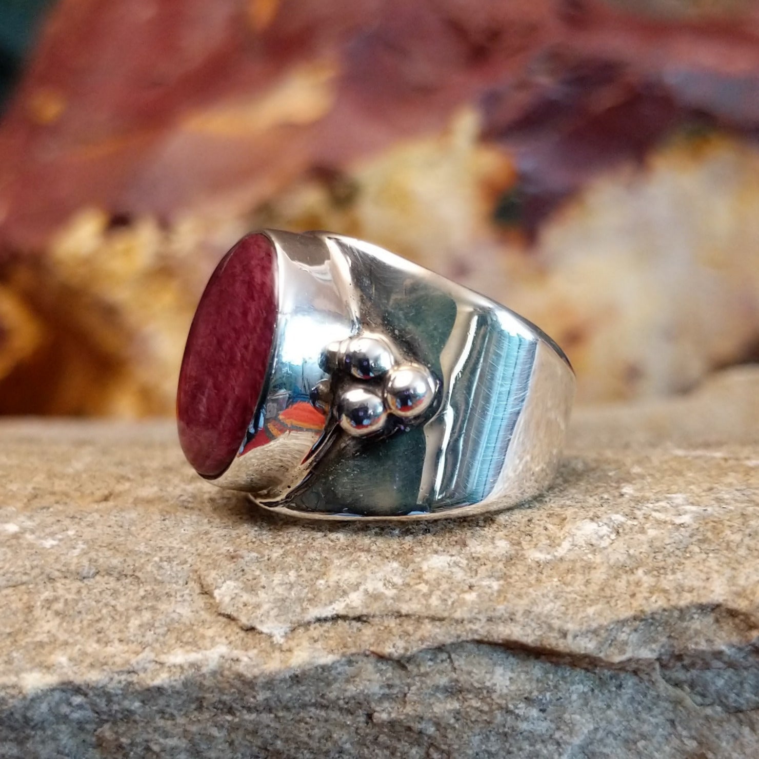 Polished spiny oyster shell ring with dot work on the band.