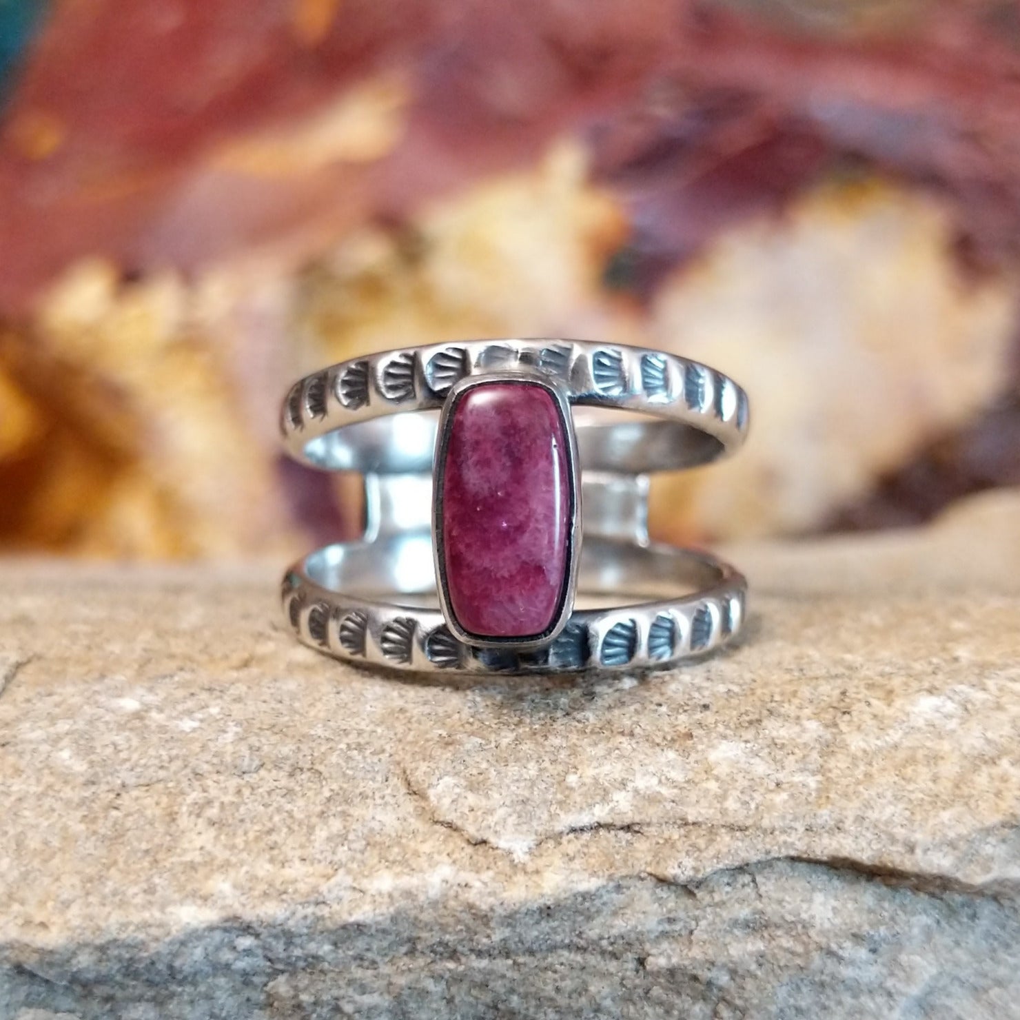 Open, layered sterling silver band with stamping and a purple spiny oyster centerpiece.