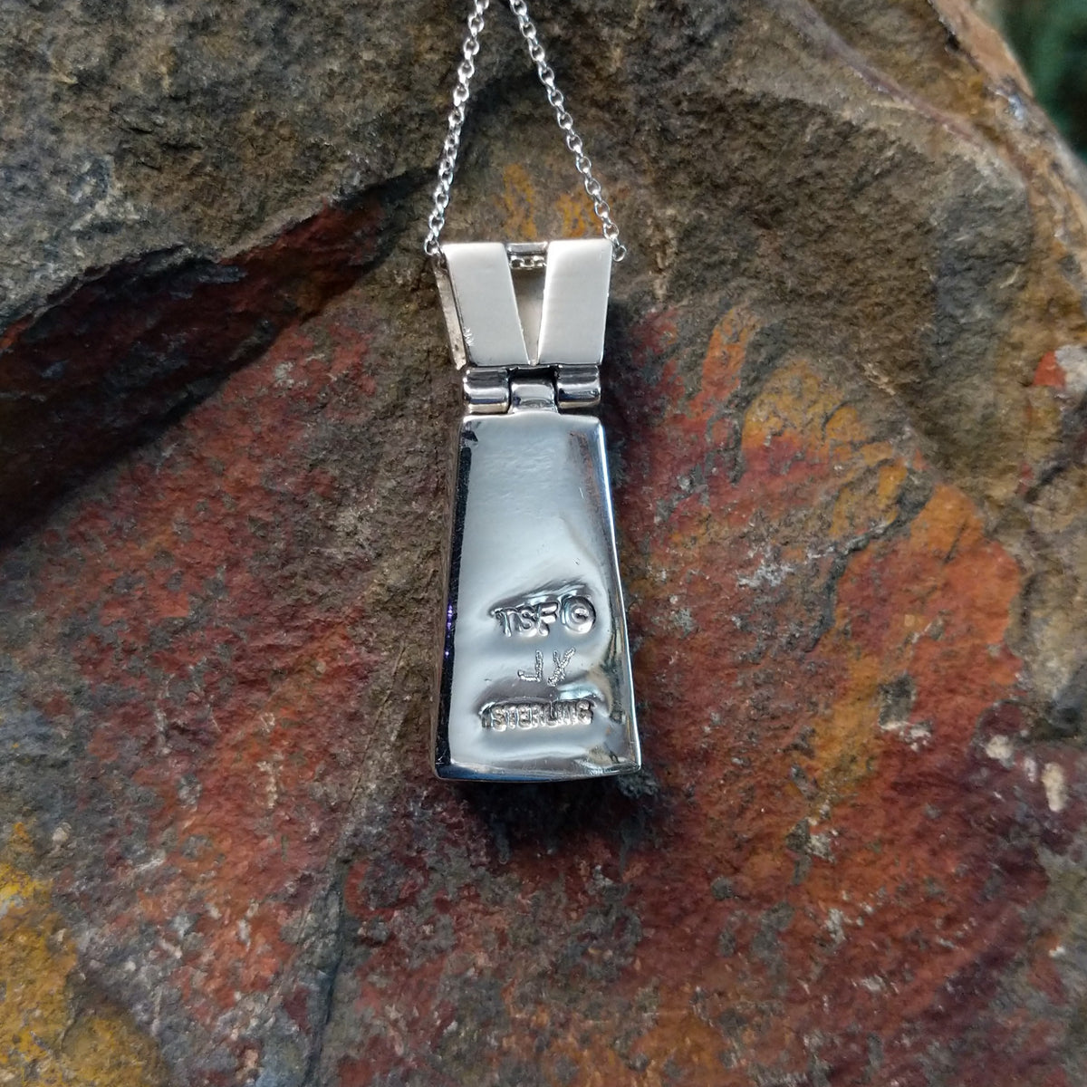 Navajo multistone cobblestone inlay pendant by J.Y. featuring turquoise, lapis, black matrix turquoise, white, and green stone inlay in a geometric sterling silver design; artisan and Sterling Silver stamp.