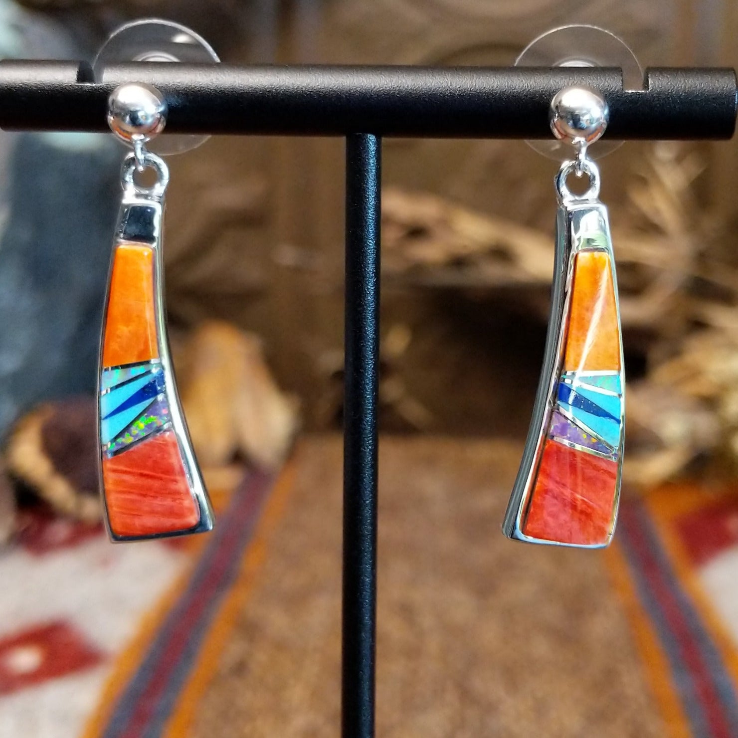 Sterling silver earrings with orange and red spiny oyster shell, turquoise, lapis, charoite, and manmade opal inlaid.