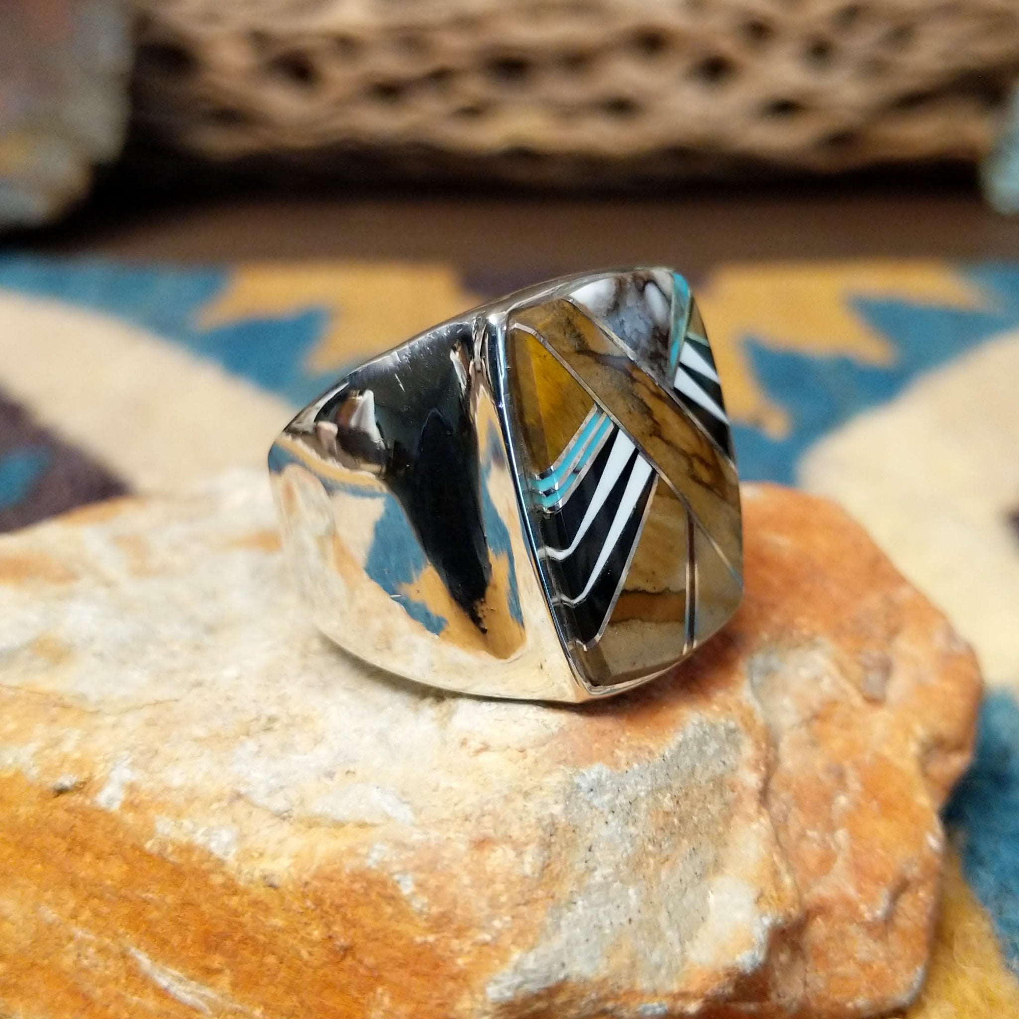 Handcrafted Navajo sterling silver ring by B.J. featuring a bold geometric inlay design in a polished silver setting with a contemporary Southwestern style; side view.
