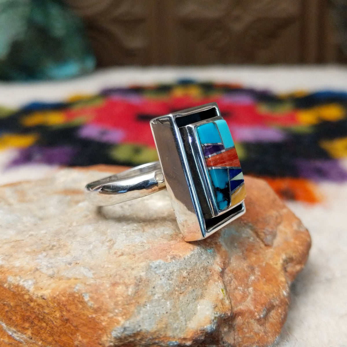 Navajo multistone mosaic shadowbox ring by A.Y. with geometric inlay and rectangular silver frame.