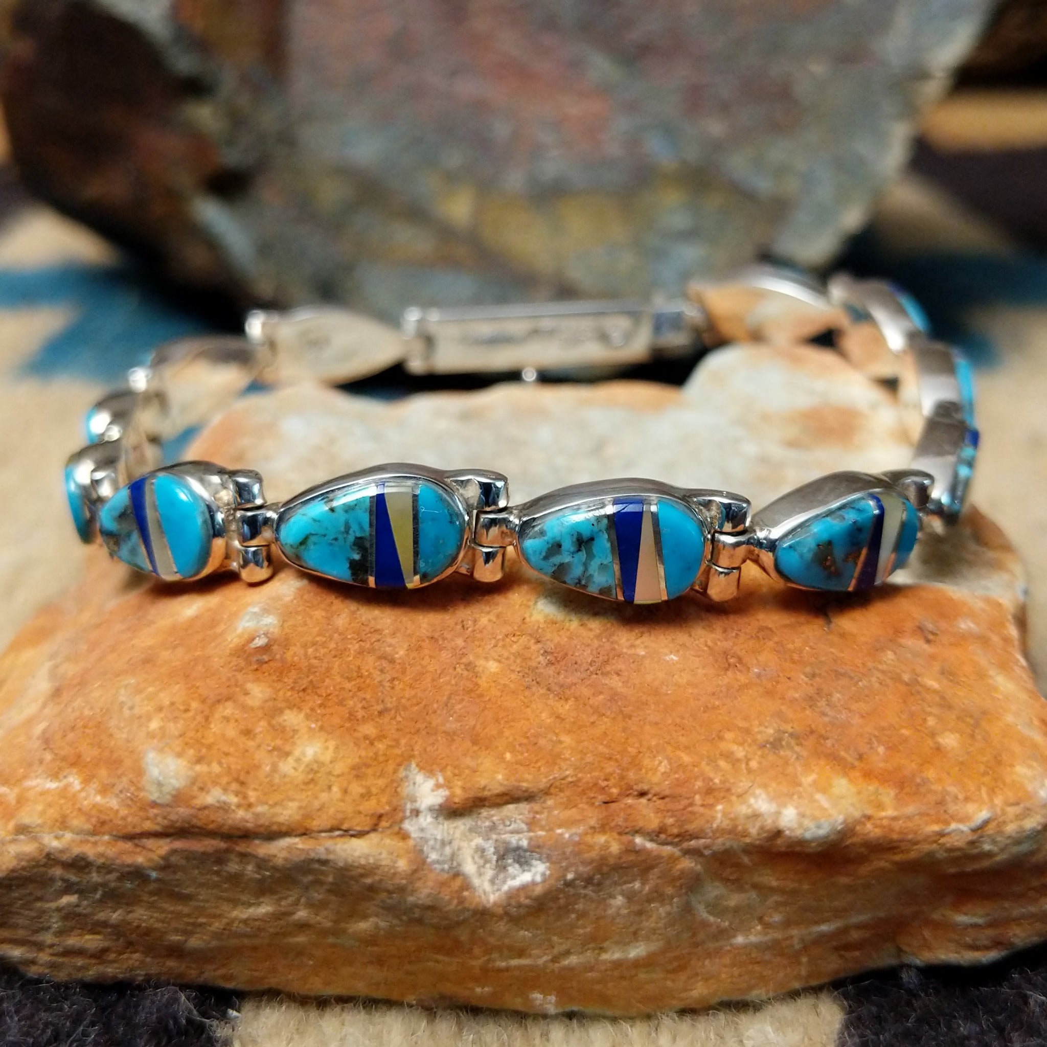 Navajo multistone inlay bracelet by V.J. with turquoise, lapis, and Mother of Pearl teardrop links in sterling silver.