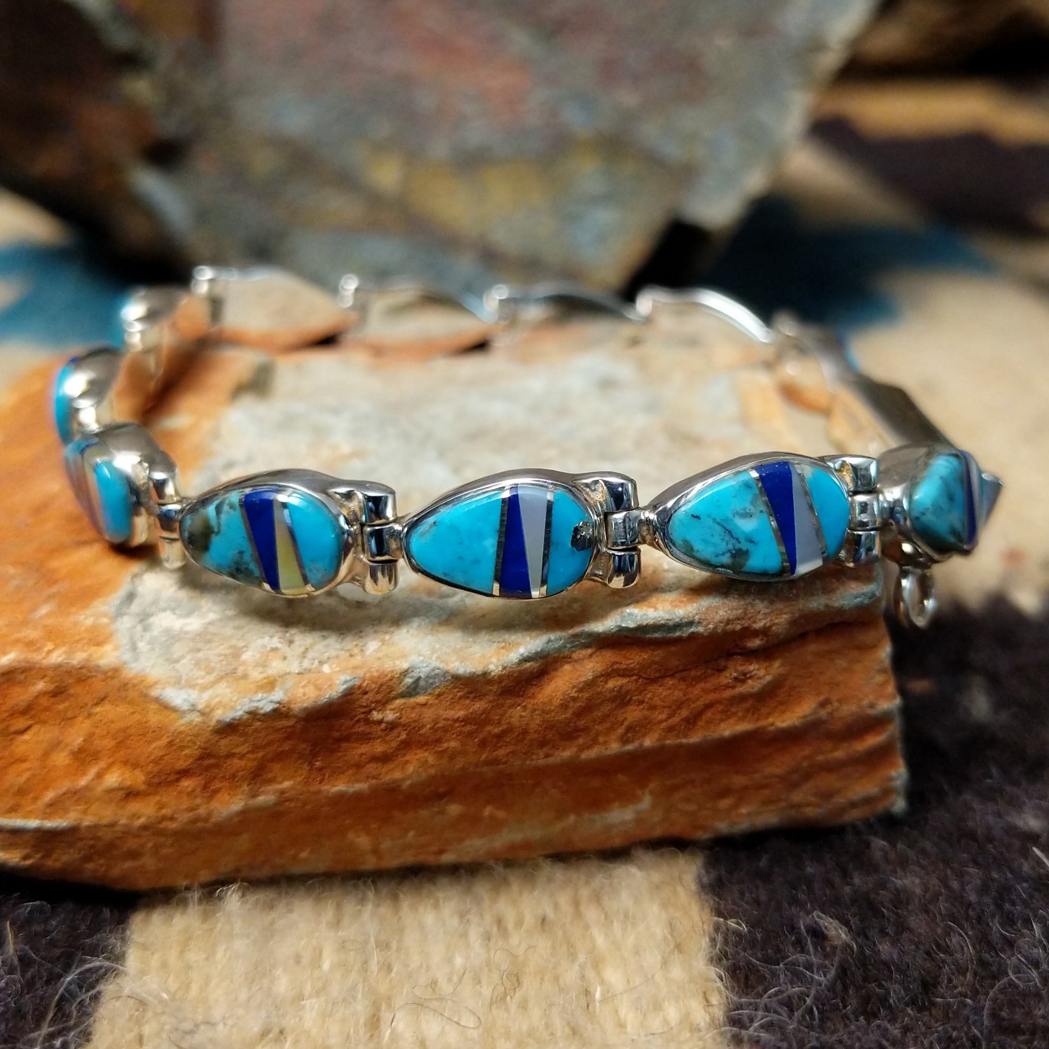 Navajo multistone inlay bracelet by V.J. with turquoise, lapis, and Mother of Pearl teardrop links in sterling silver.