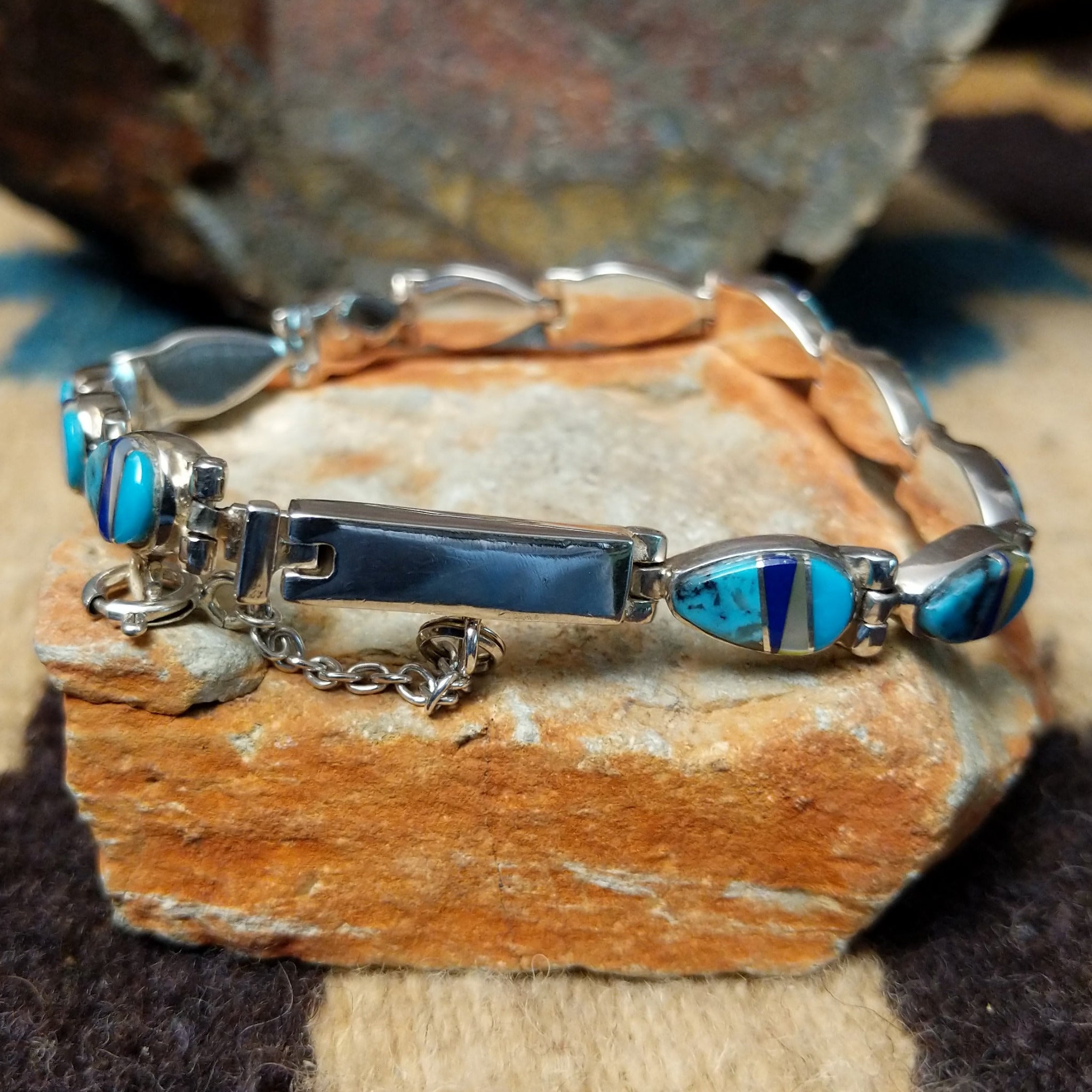 Navajo multistone inlay bracelet by V.J. with turquoise, lapis, and Mother of Pearl teardrop links in sterling silver; underside and clasp view.