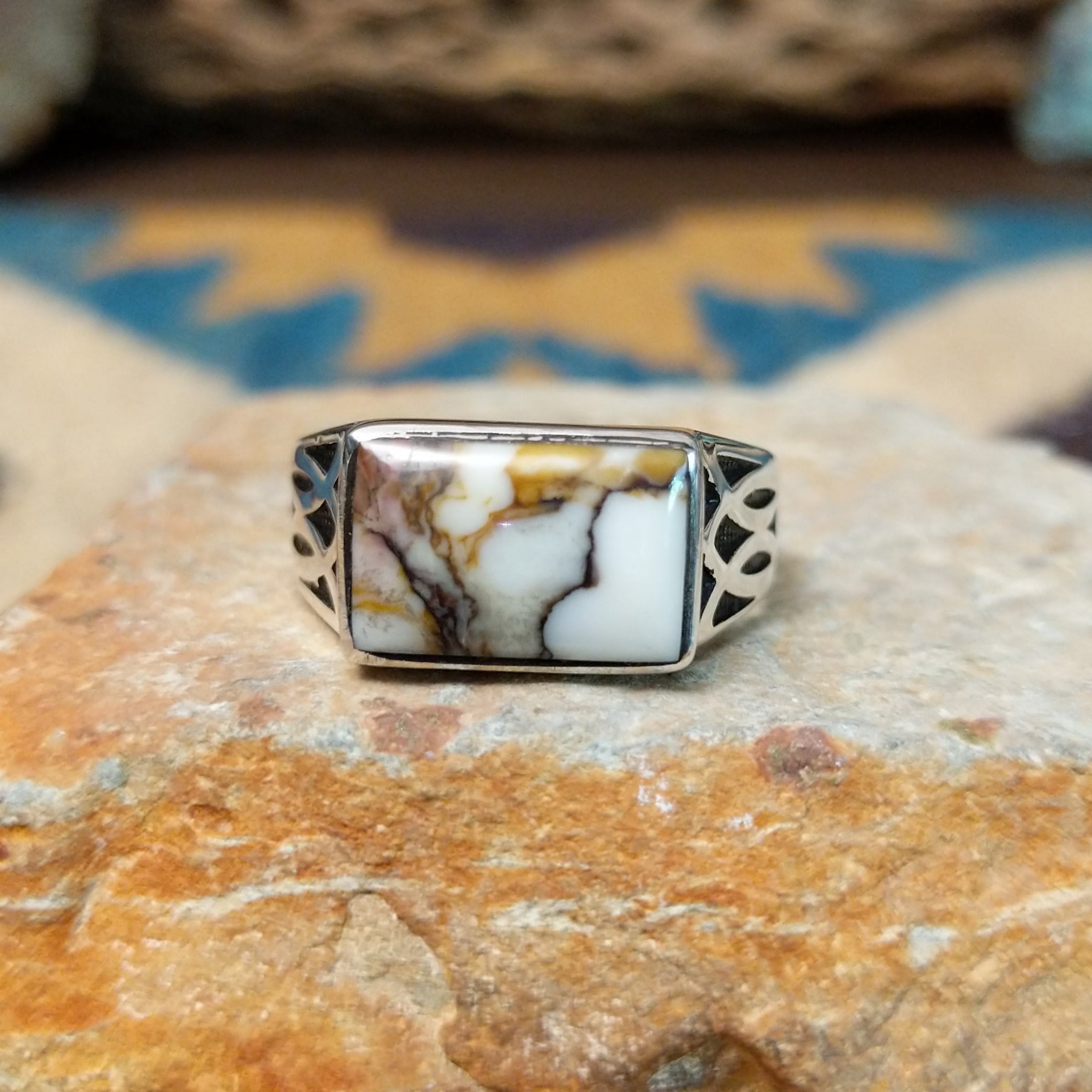 Handcrafted Navajo sterling silver ring featuring a rectangular Wild Horse gemstone with natural white, brown, and golden veining, set in a smooth bezel with openwork cutout details on the band.