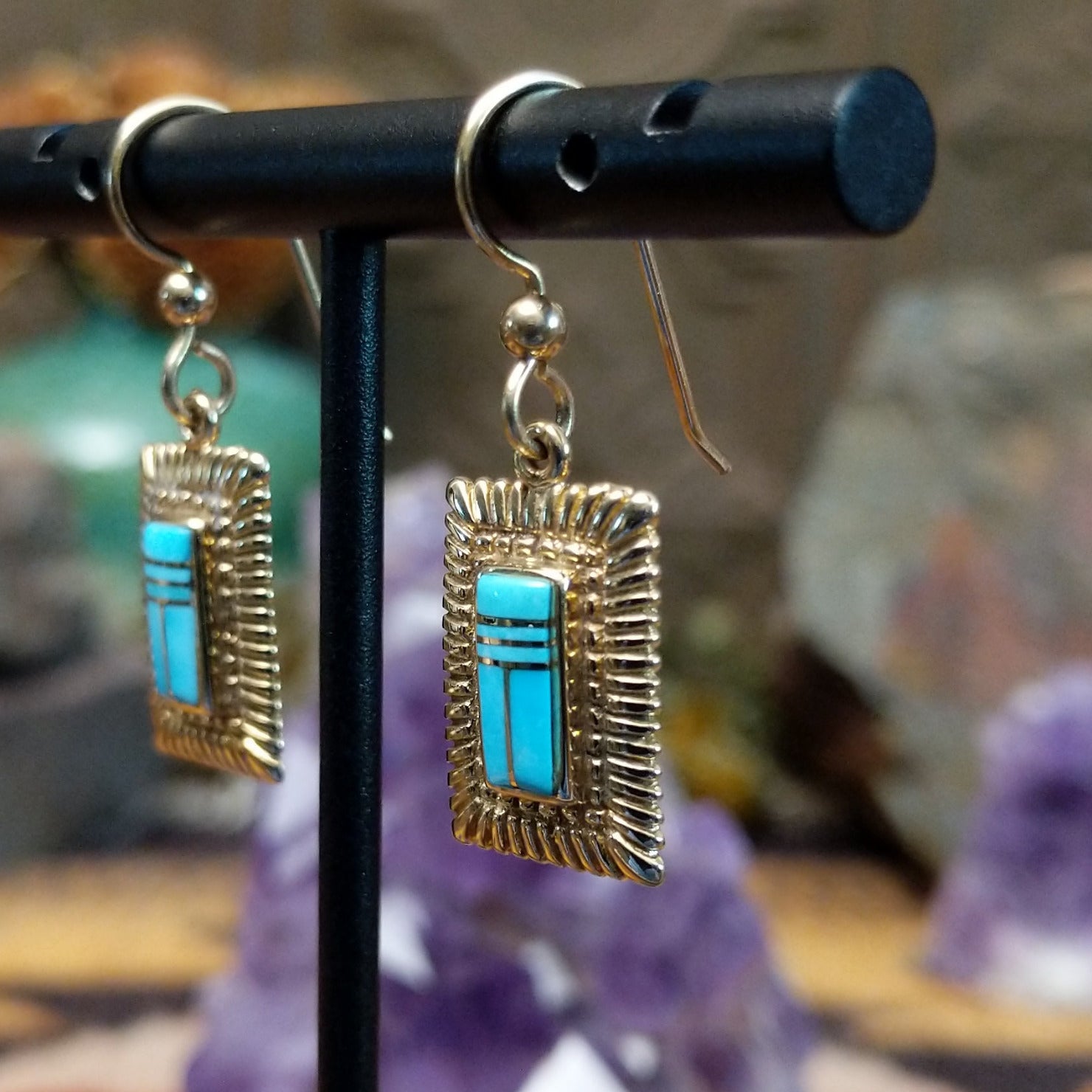 14kt gold Navajo dangle earrings featuring rectangular turquoise inlay with geometric line details and textured gold frames.