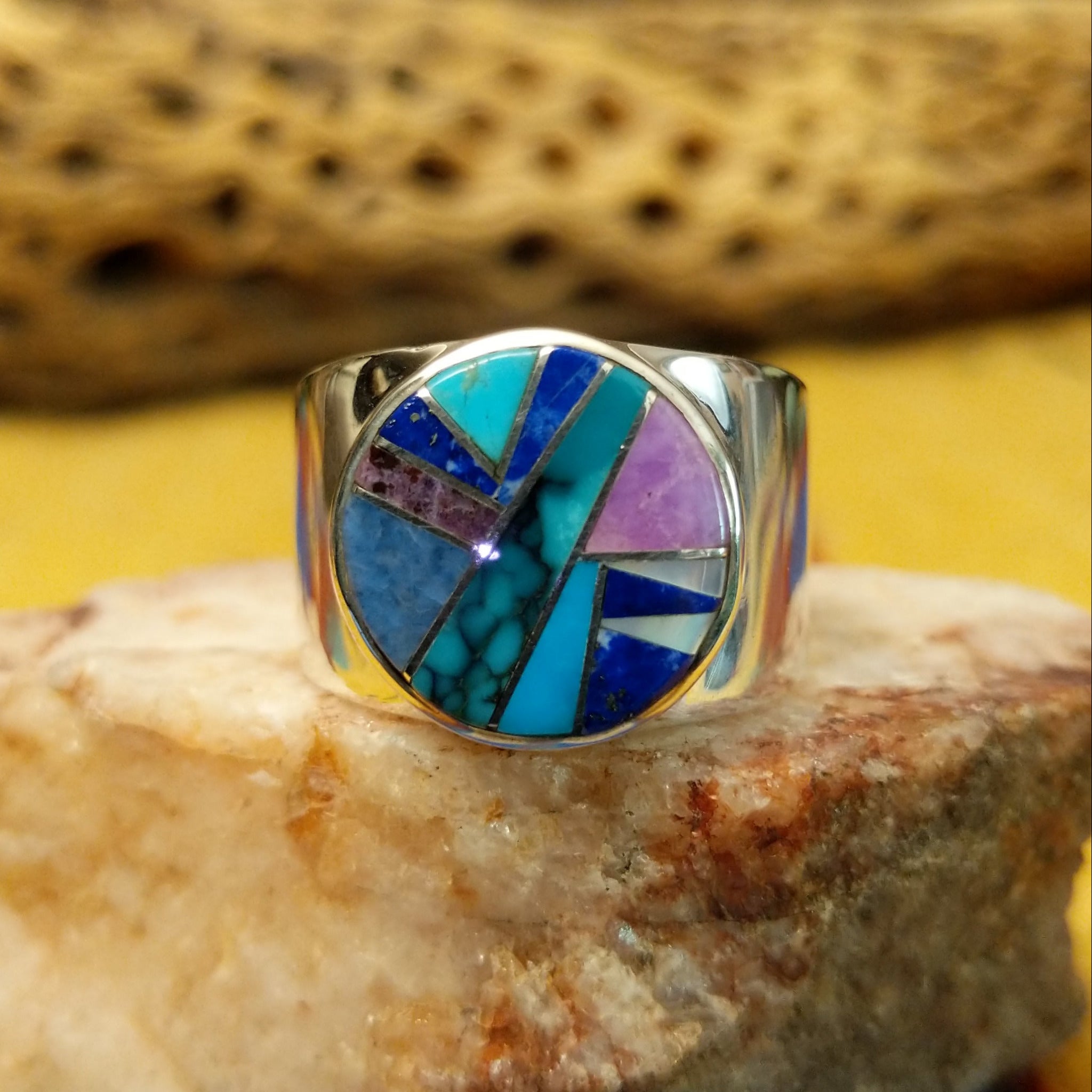 Navajo round multistone inlay ring, featuring a circular arrangement of natural stones set in a handcrafted sterling silver band with traditional Southwestern-inspired craftsmanship.