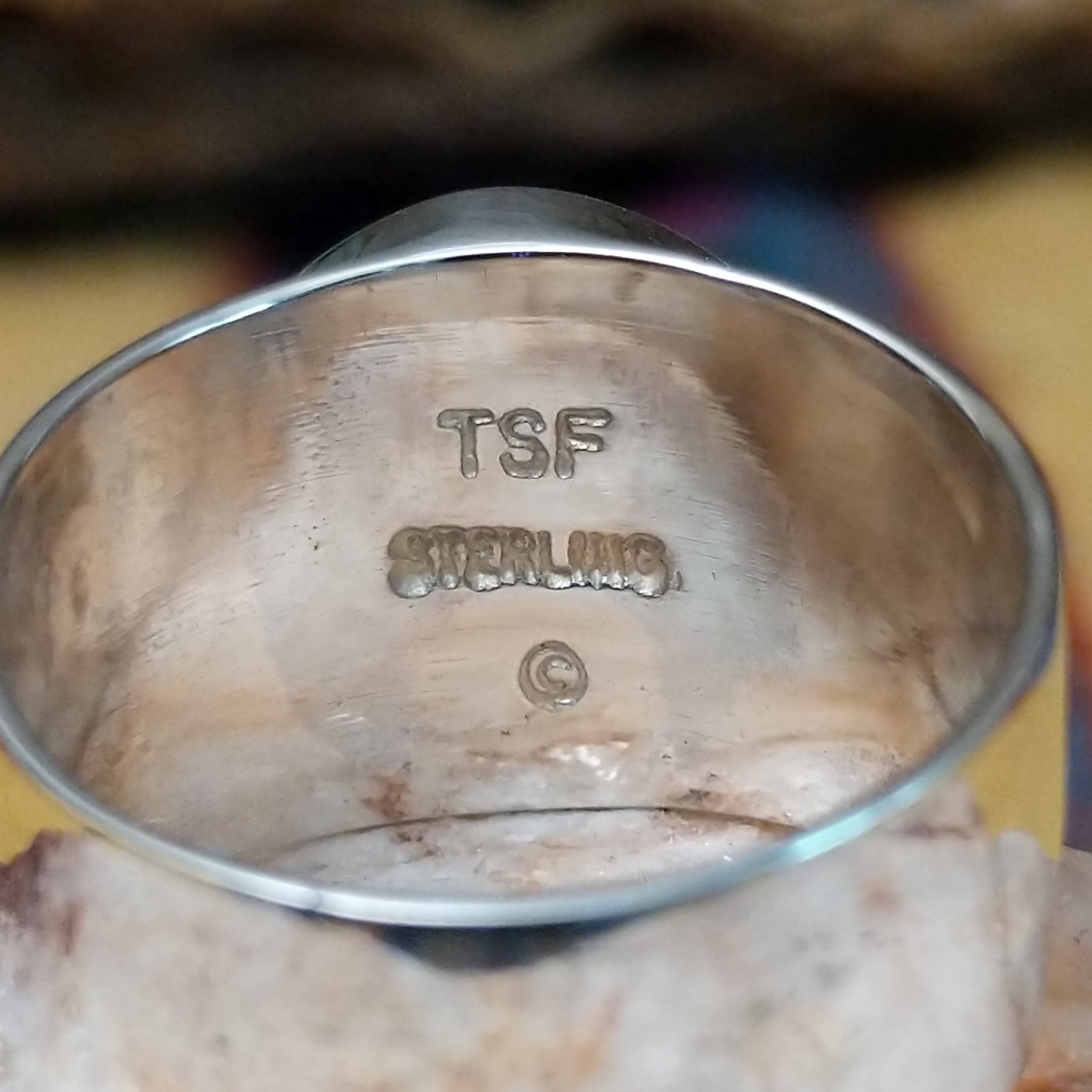 Navajo round multistone inlay ring, featuring a circular arrangement of natural stones set in a handcrafted sterling silver band with traditional Southwestern-inspired craftsmanship. Artisan and Sterling Silver stamp.