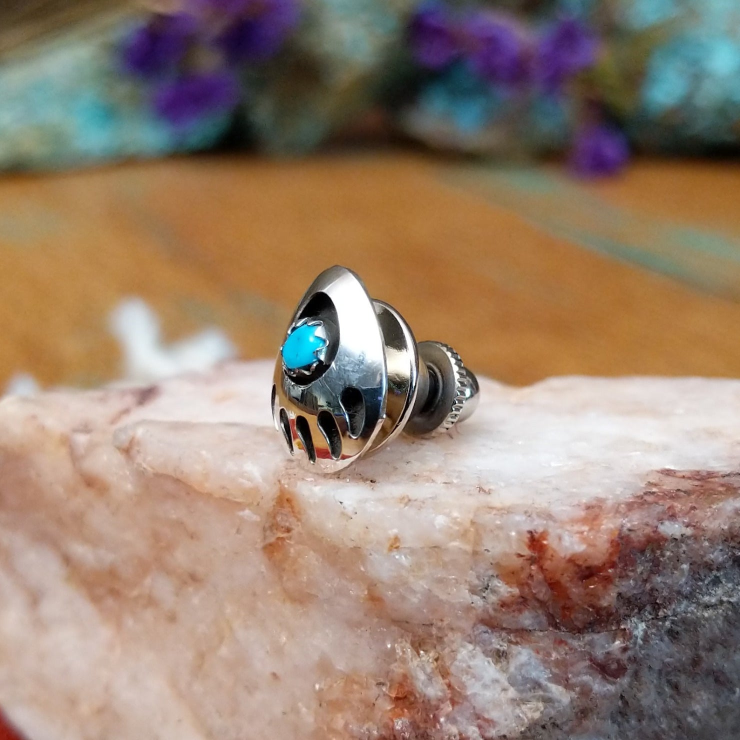 Sterling silver Navajo bear paw tie tack with turquoise center stone.