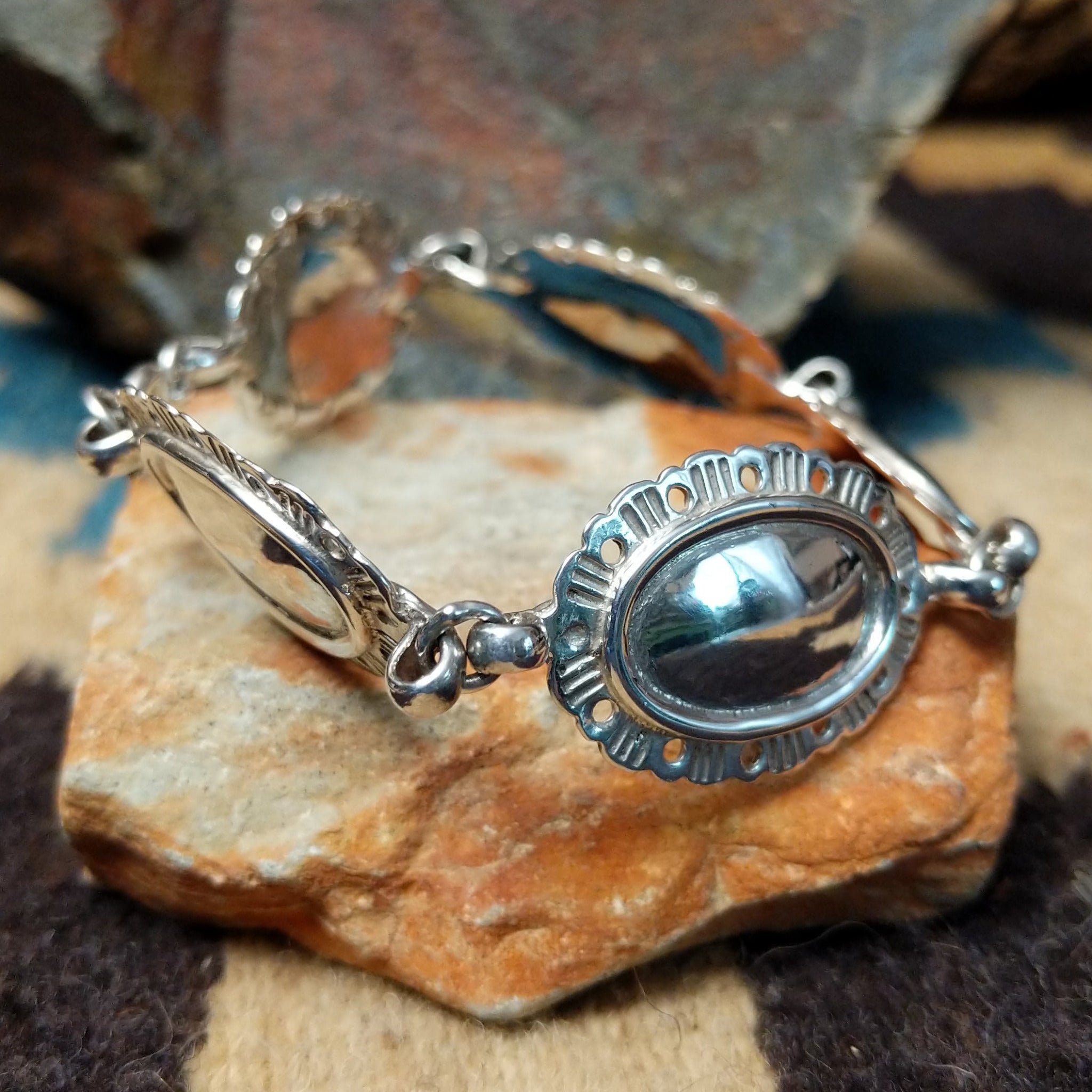 Navajo sterling silver concho bracelet with hand-stamped concho designs and traditional Southwestern detailing.