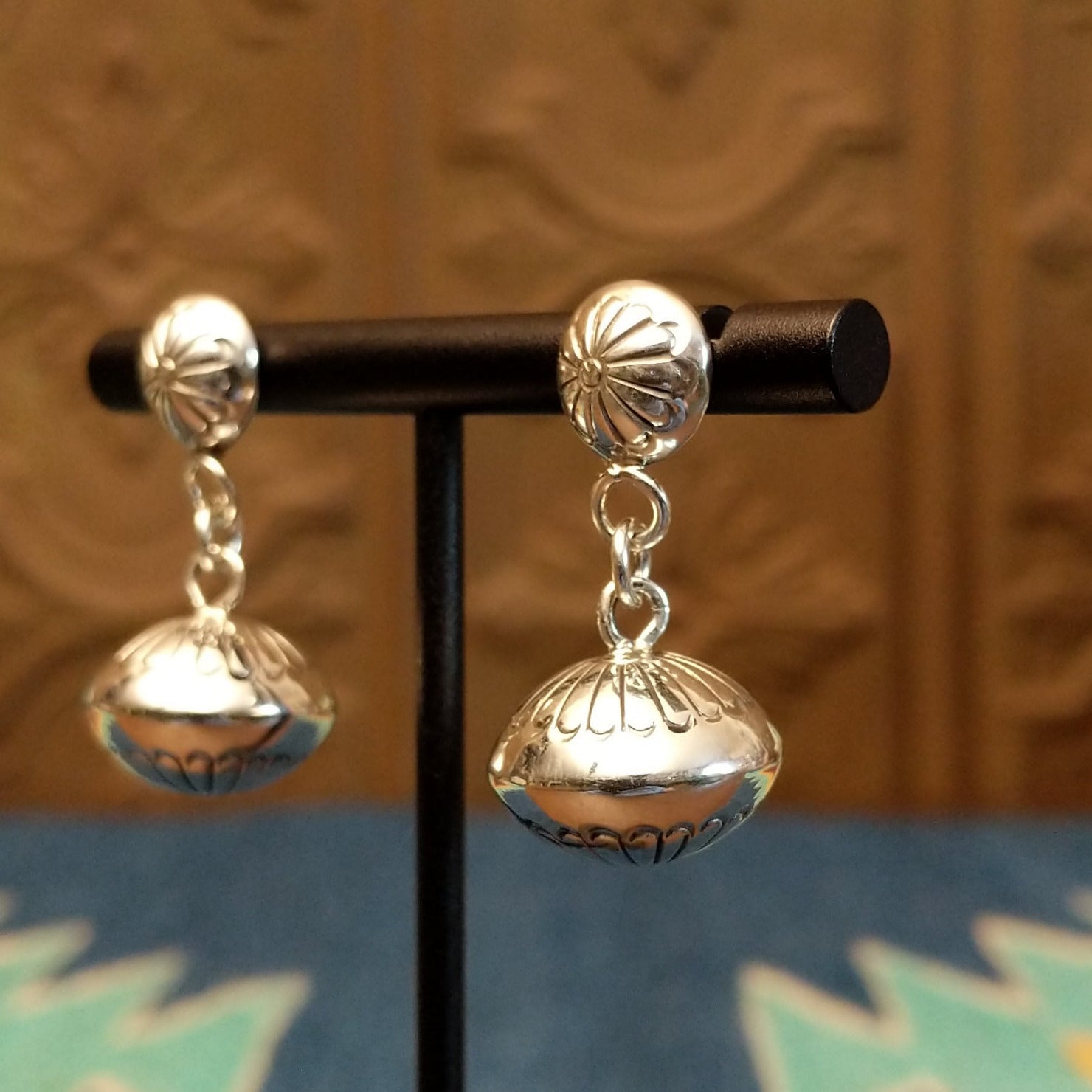 Dangle earrings with stud floral accents and chain.