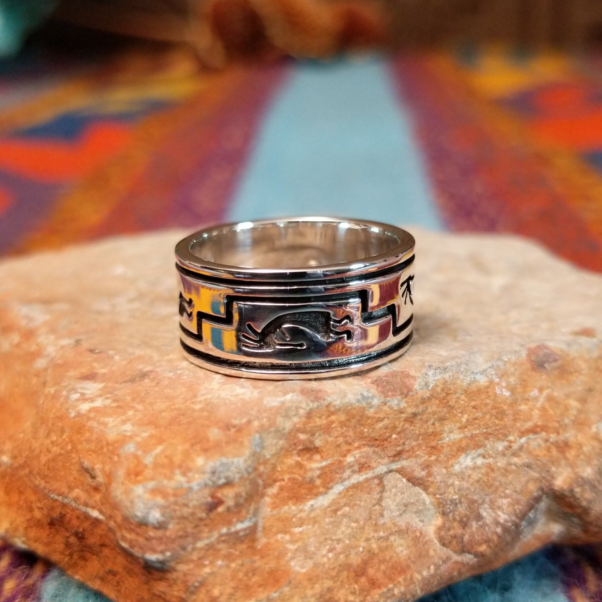 Navajo silver ring by I. Kee with Kokopelli figure and recessed geometric design.