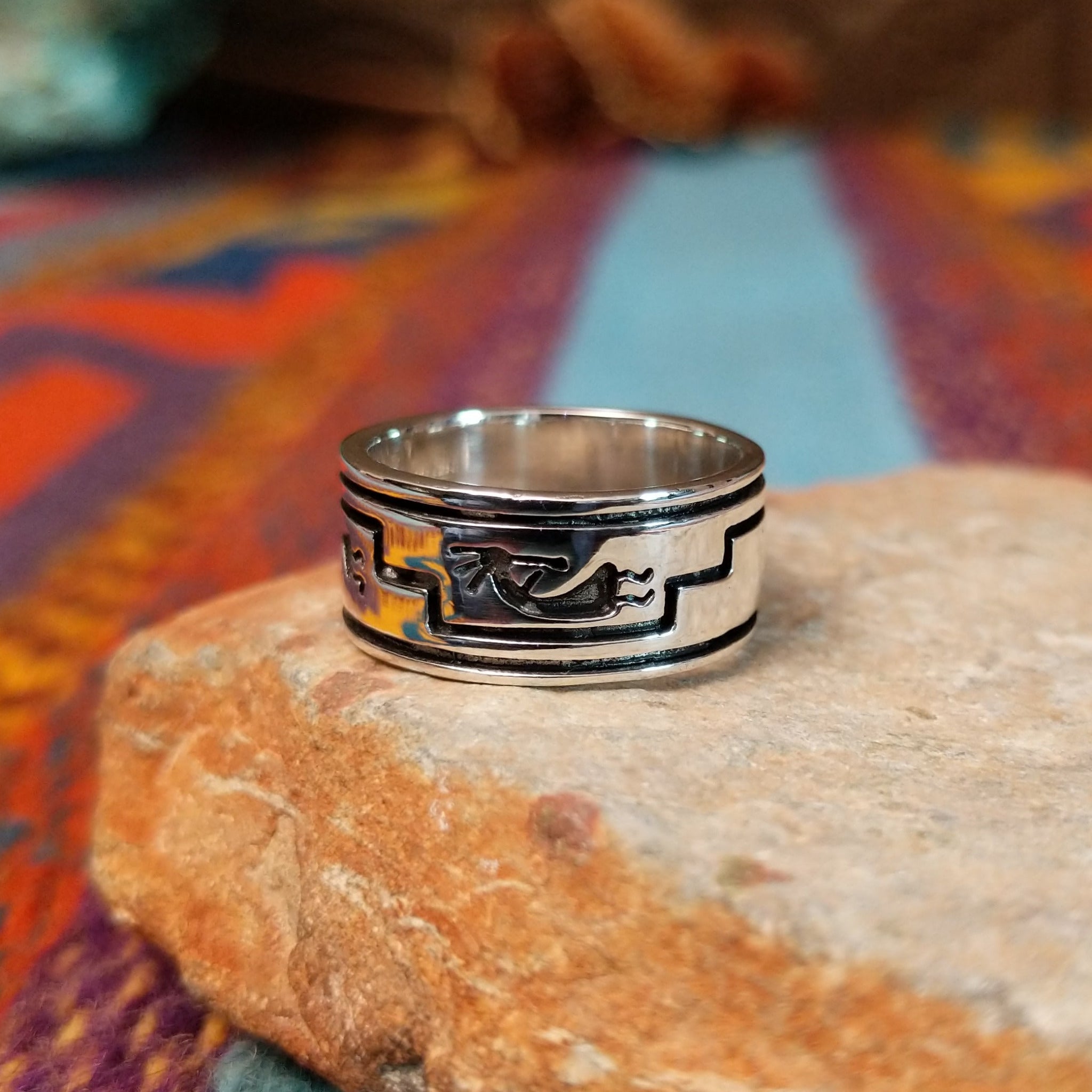 Navajo silver ring by I. Kee with Kokopelli figure and recessed geometric design.