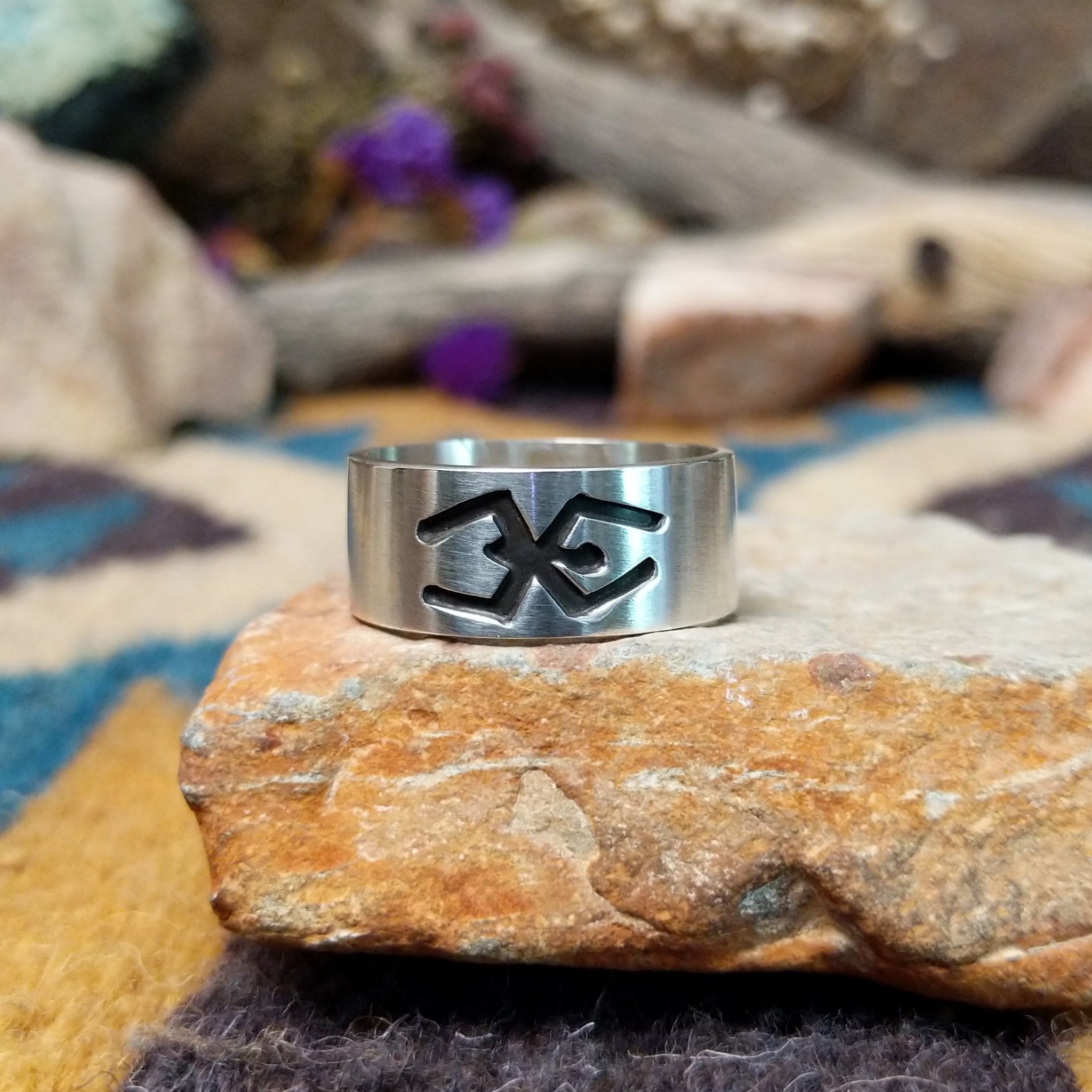 Sterling silver Navajo ring by L.G. with a brushed finish and hand-cut geometric design.