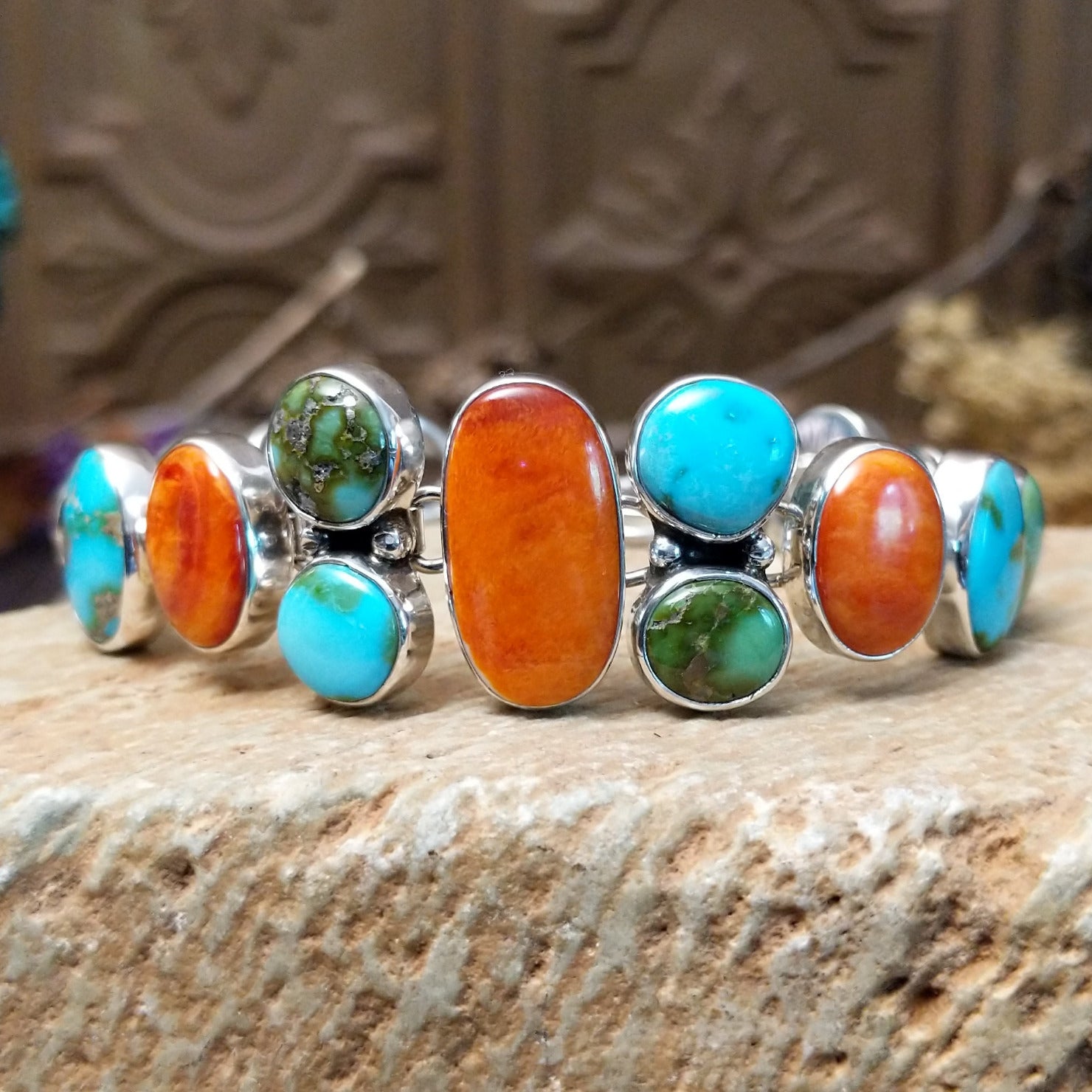 Sterling silver bracelet with turquoise and orange spiny oyster shell set in multiple bezels.