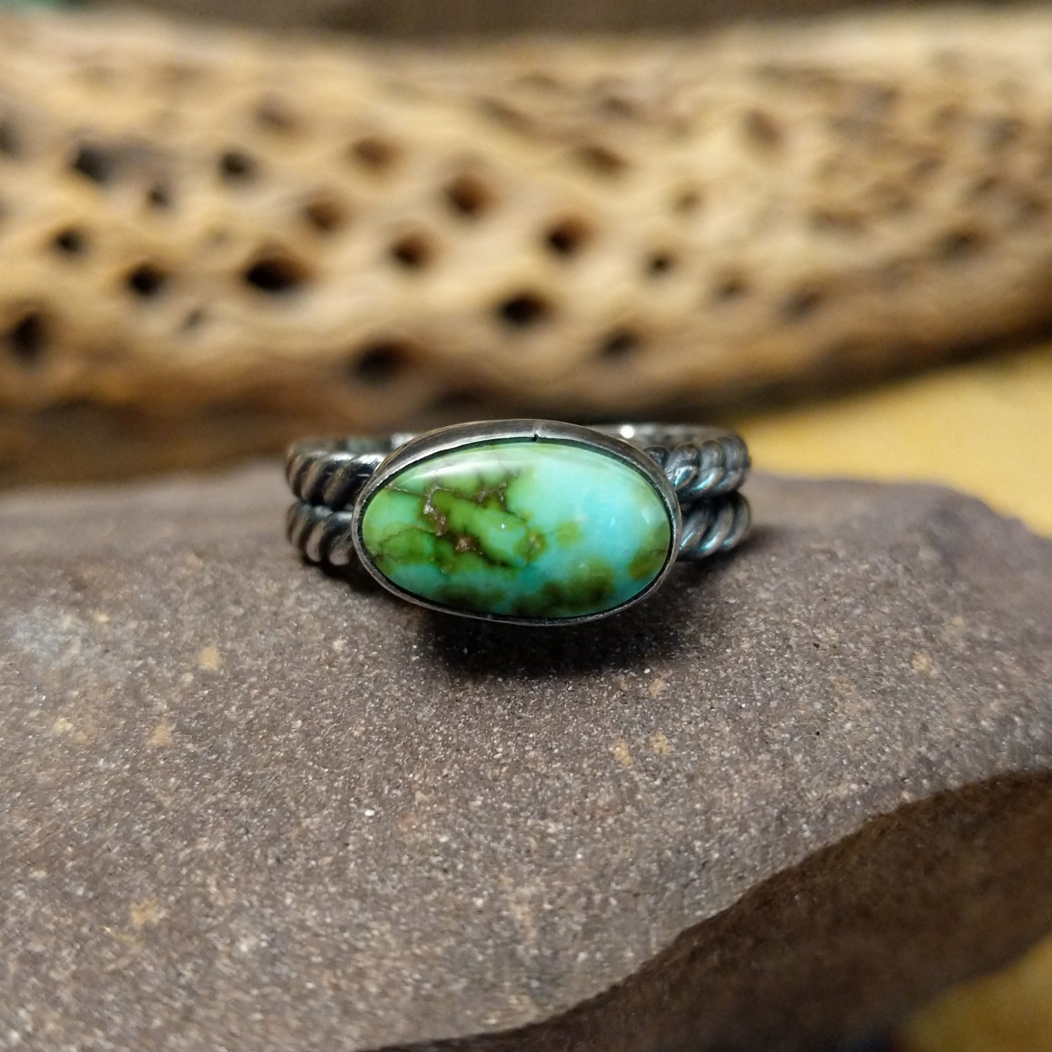 Navajo Sonoran Gold turquoise roped ring, featuring a blue and green Sonoran Gold turquoise stone surrounded by a twisted rope border in a handcrafted sterling silver band.
