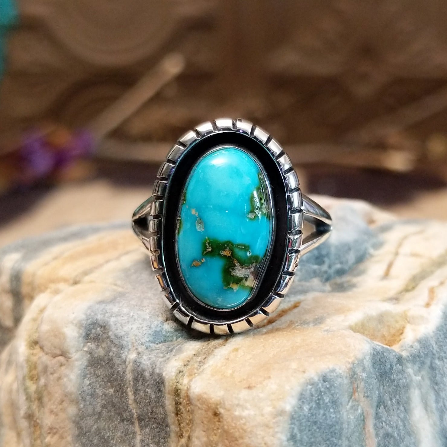 Sterling silver ring with Sonoran gold turquoise set in an oval, shadowbox setting.