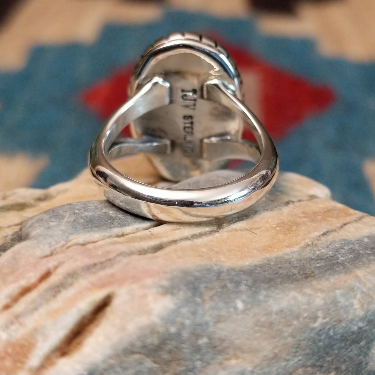 Sterling silver ring with Sonoran gold turquoise set in an oval, shadowbox setting.