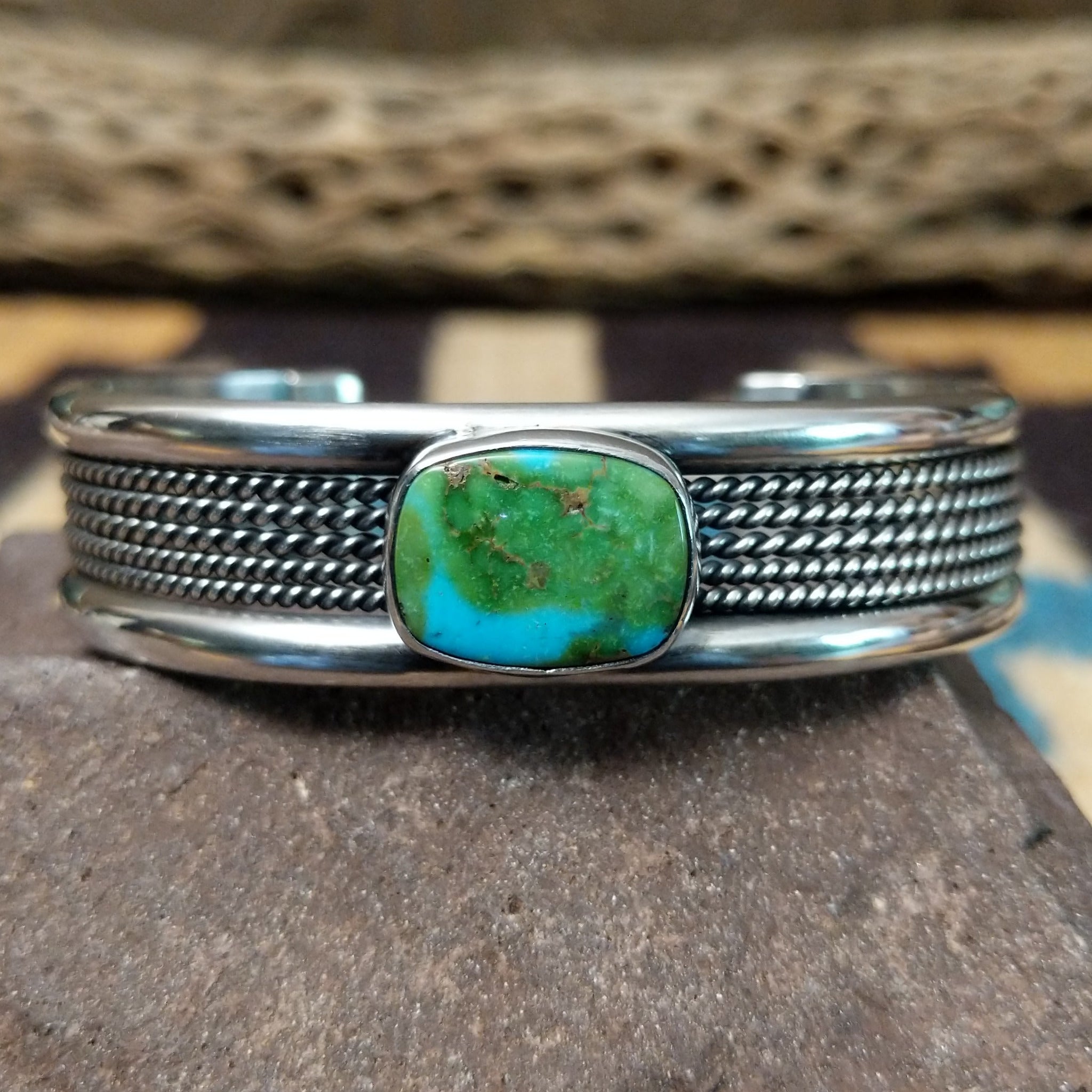 Navajo Sonoran Gold turquoise cuff by H.R.M. with a natural blue-green turquoise stone on a triple-shank sterling silver cuff.