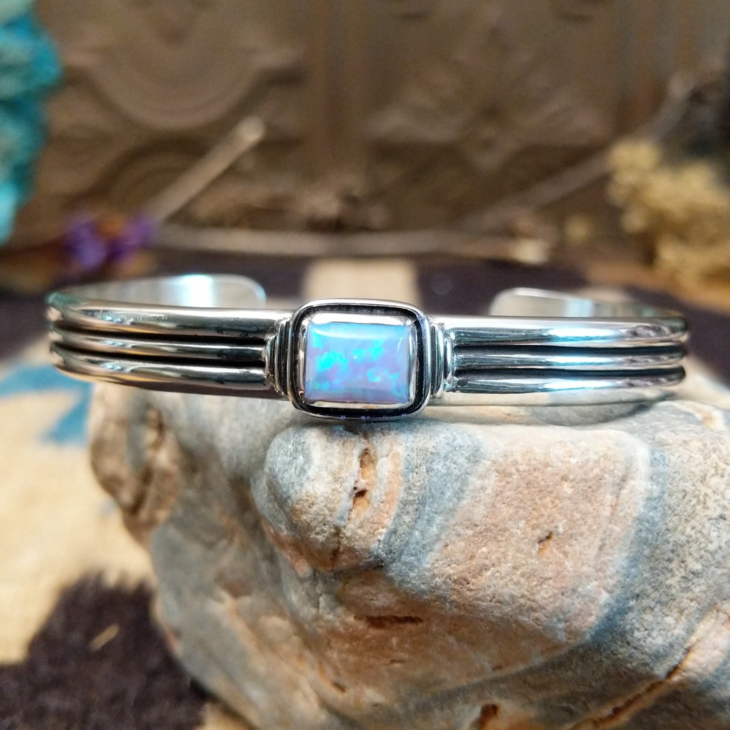 Sterling silver cuff with blue manmade opal set in a square bezel and layered band.