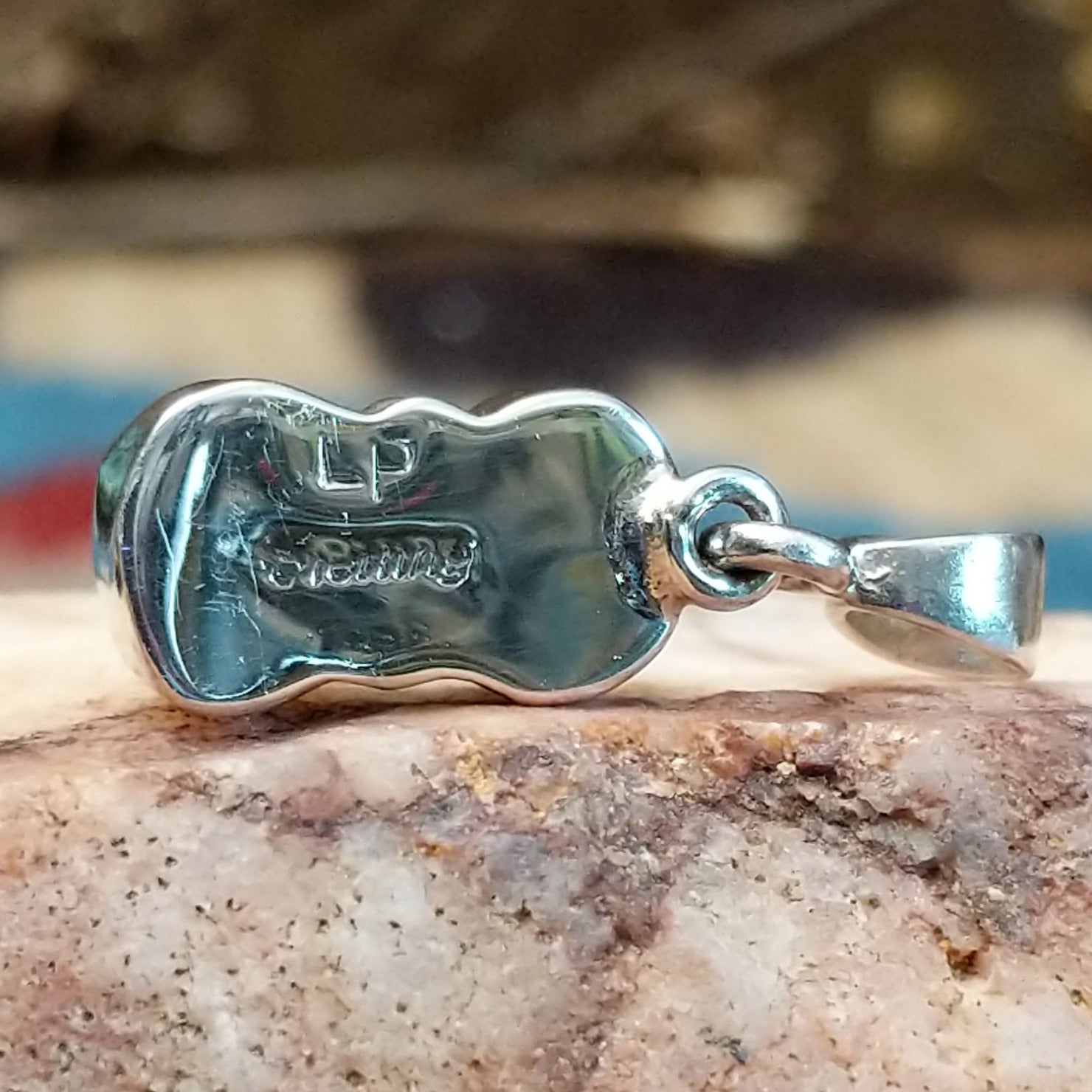 Close-up of the artisan's stamped signature.