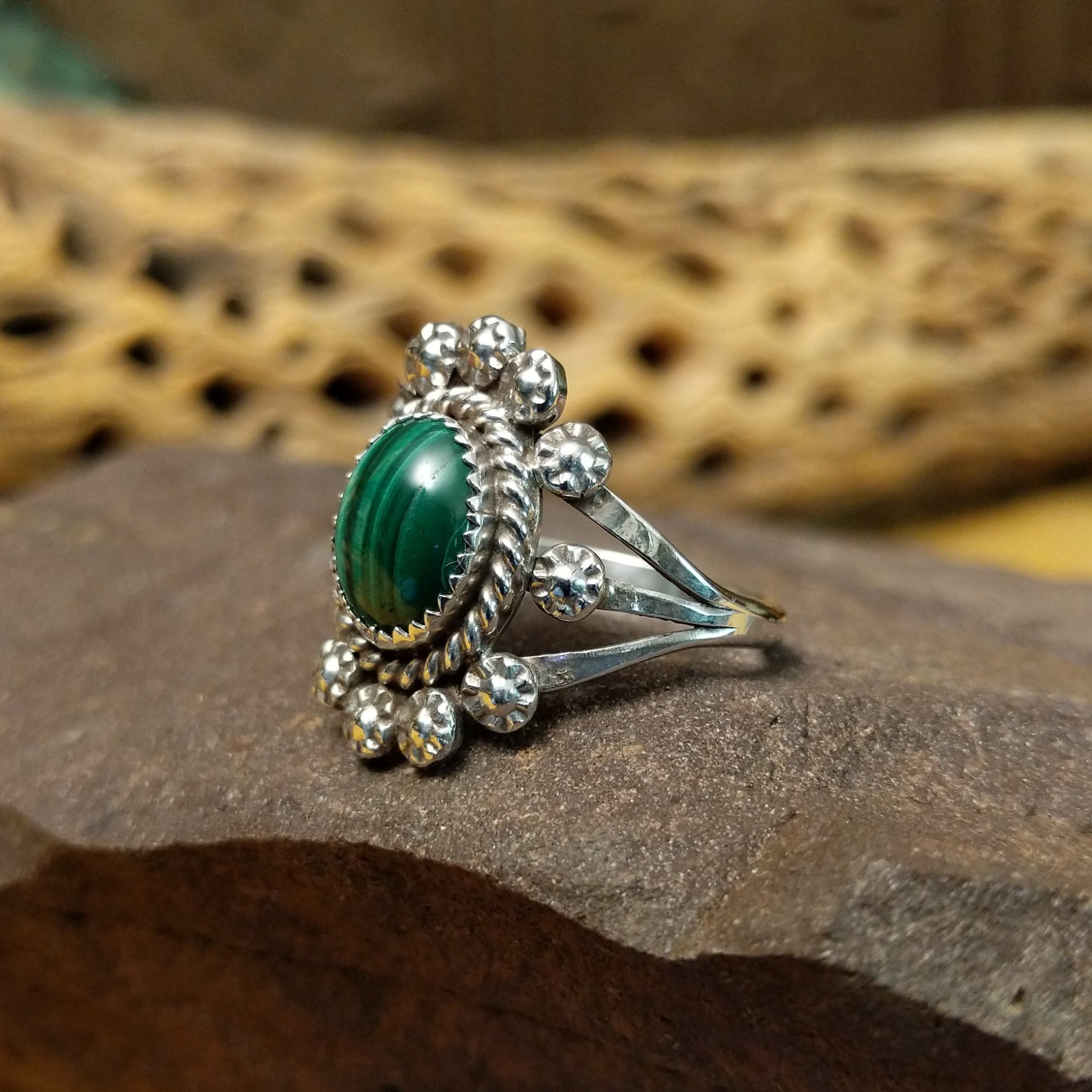 Navajo Starry malachite ring, featuring a vibrant green malachite stone with natural banding set in a handcrafted sterling silver band with Southwestern-inspired metalwork. Side view.