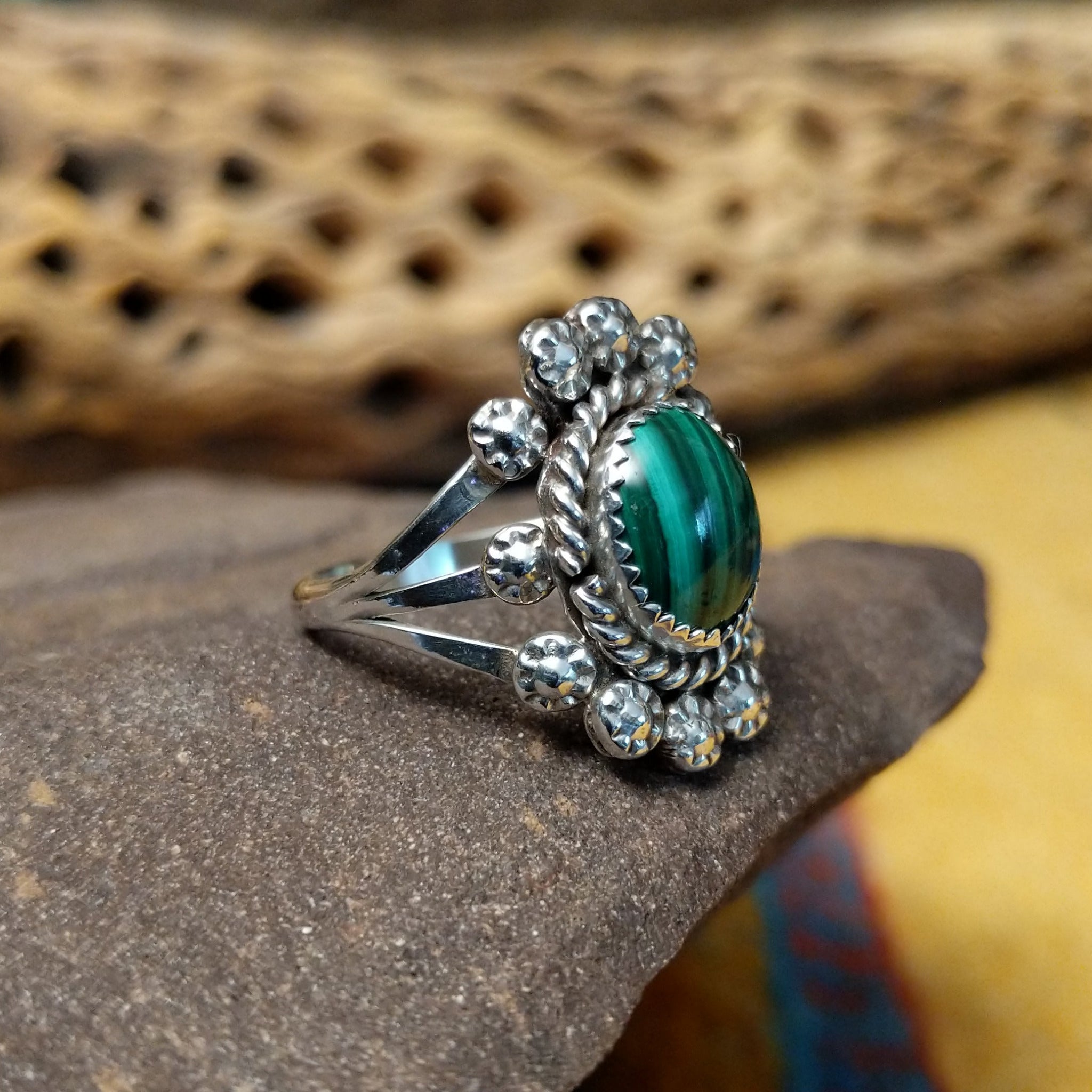 Navajo Starry malachite ring, featuring a vibrant green malachite stone with natural banding set in a handcrafted sterling silver band with Southwestern-inspired metalwork. Side view.