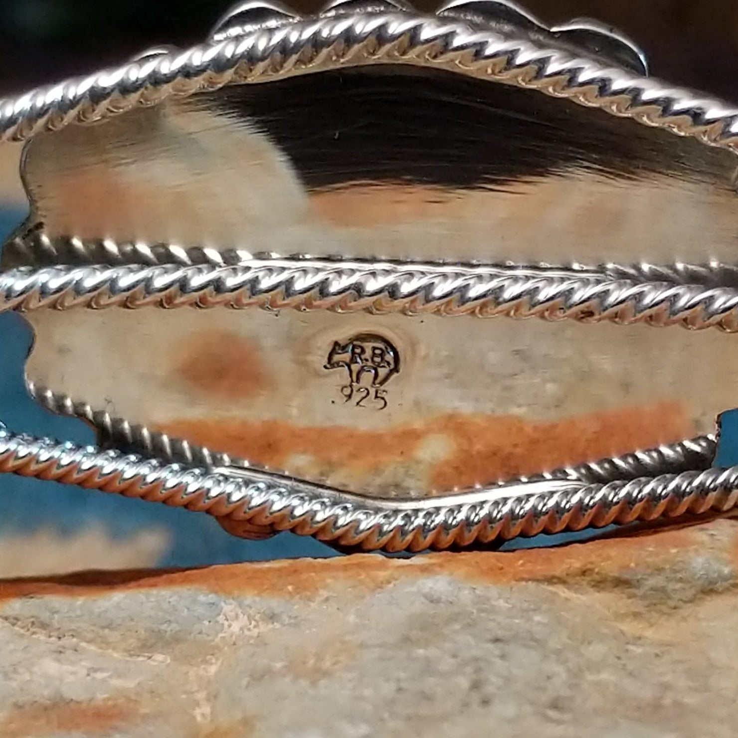 Navajo Starry White Buffalo cuff, featuring a white buffalo stone with bold black matrix patterns set in handcrafted Southwestern-inspired metalwork. Artisan and .925 Silver stamp.