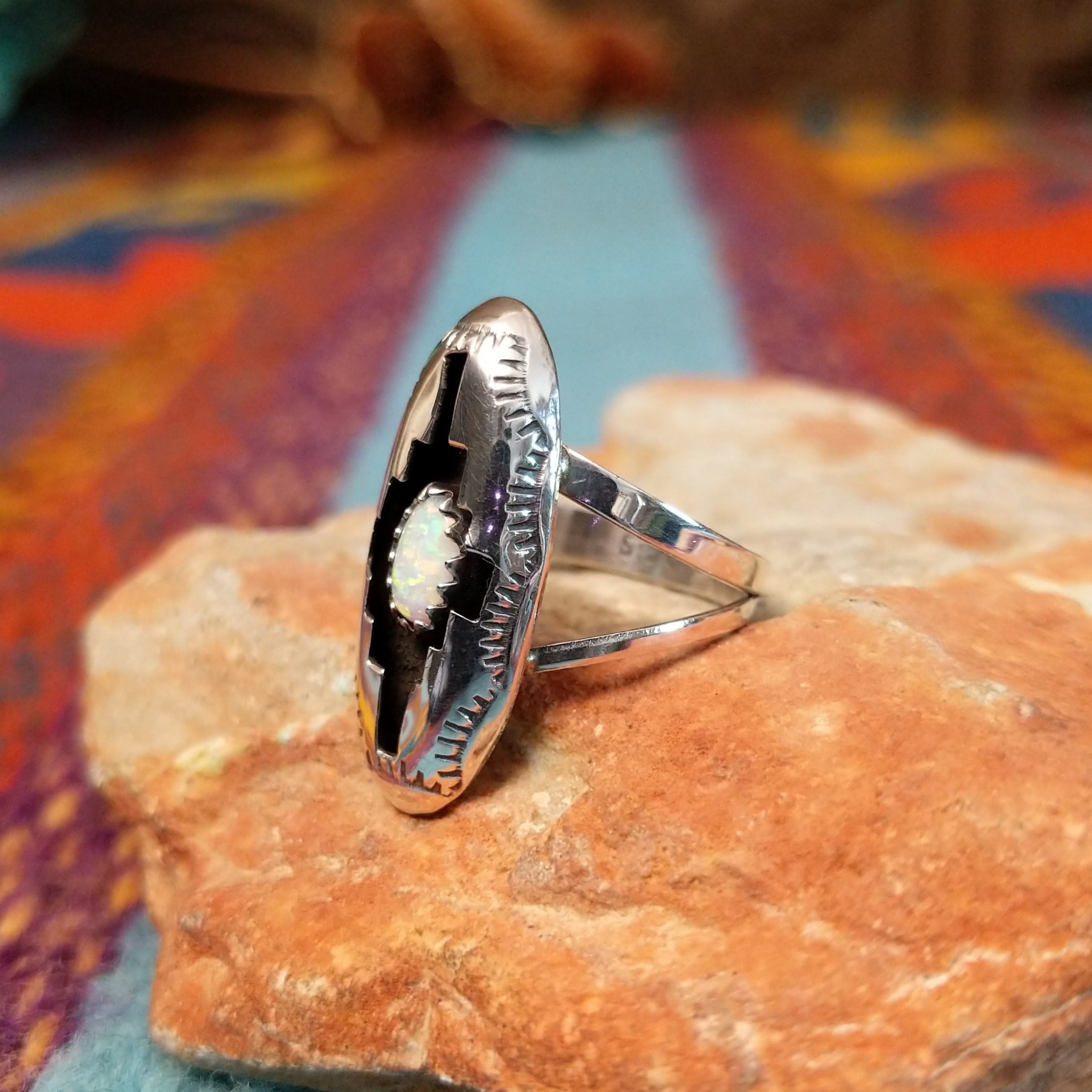 Navajo silver shadowbox ring by P. with stepped design and manmade opal center.
