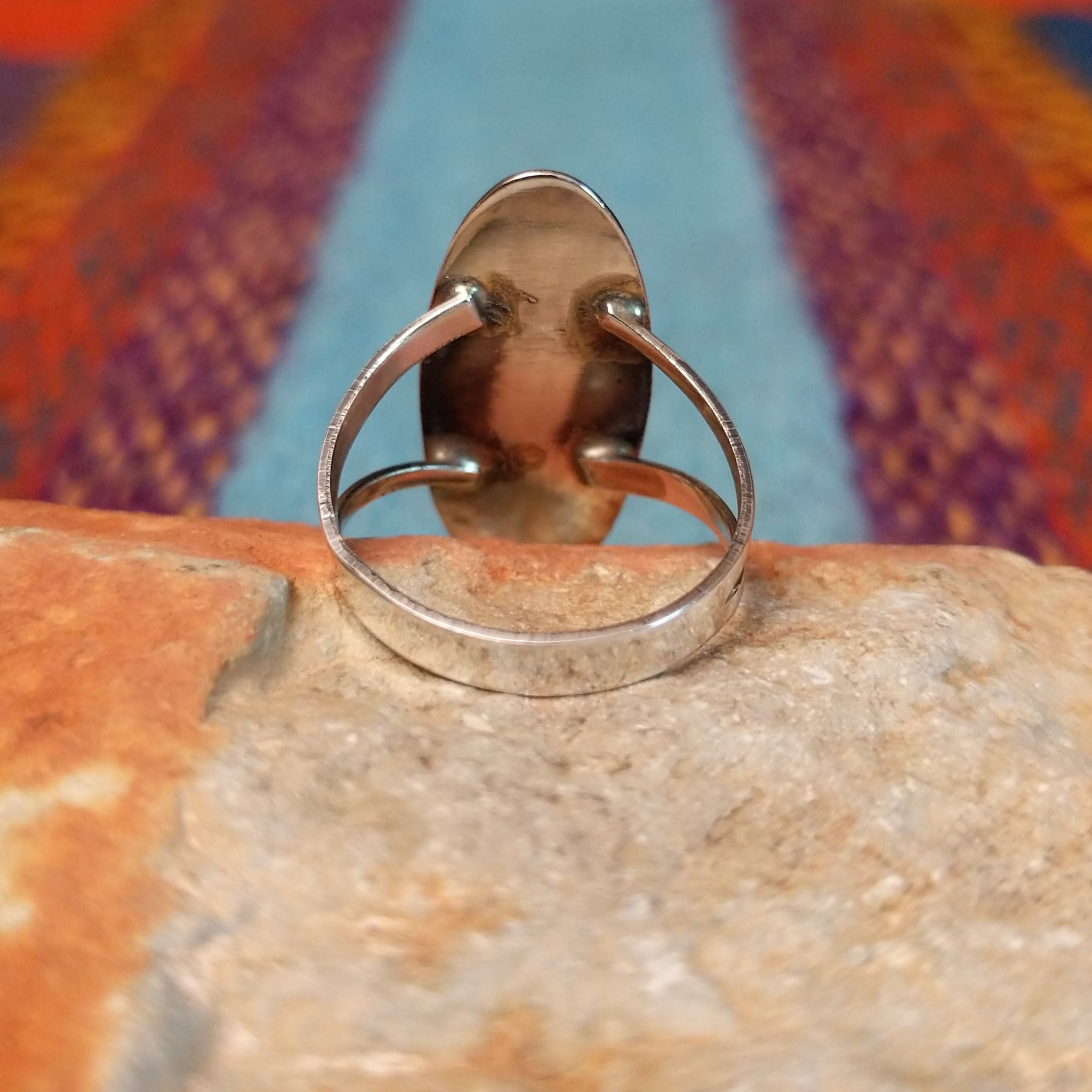 Navajo silver shadowbox ring by P. with stepped design and manmade opal center.