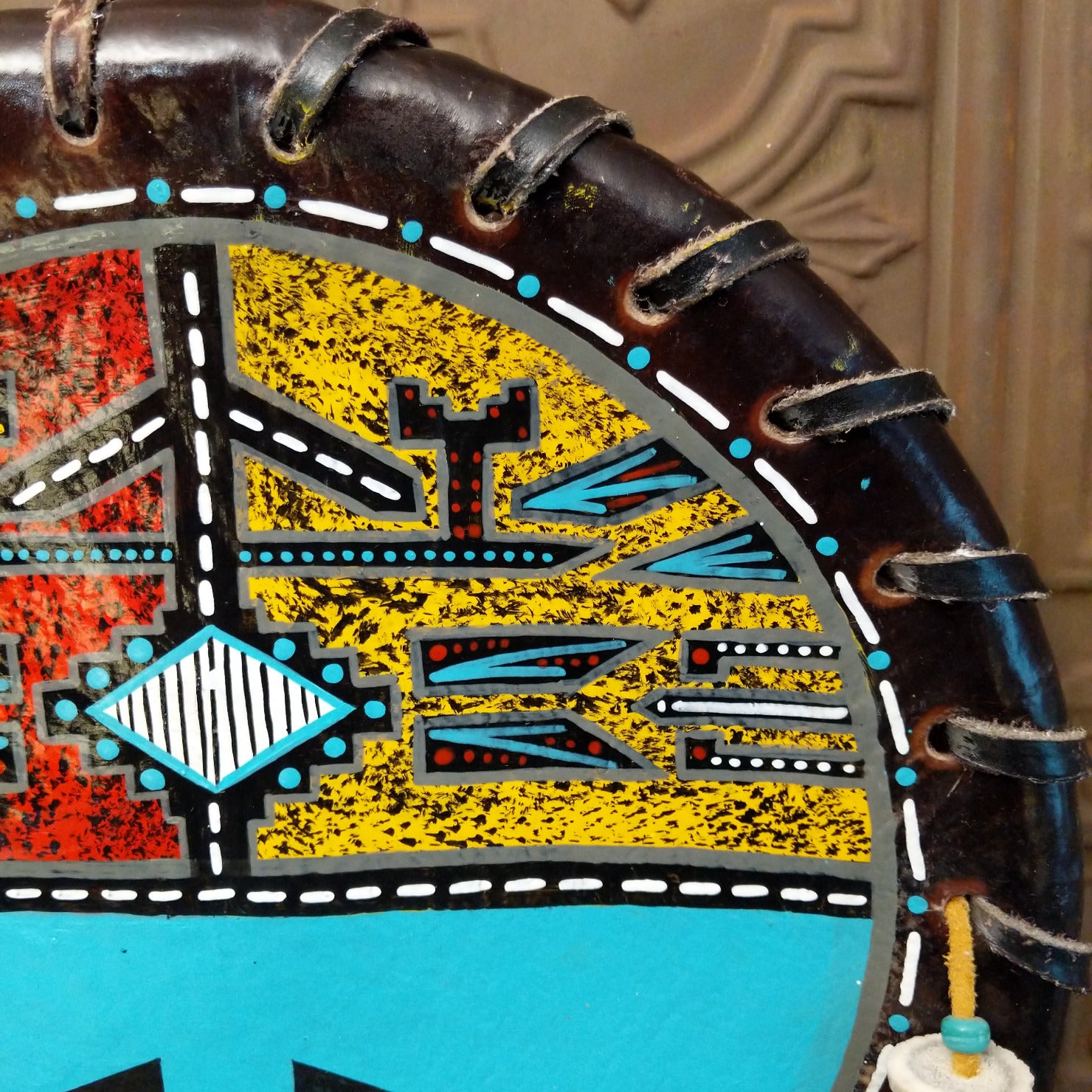 A close-up of the painted yellow design with various colorful motifs.