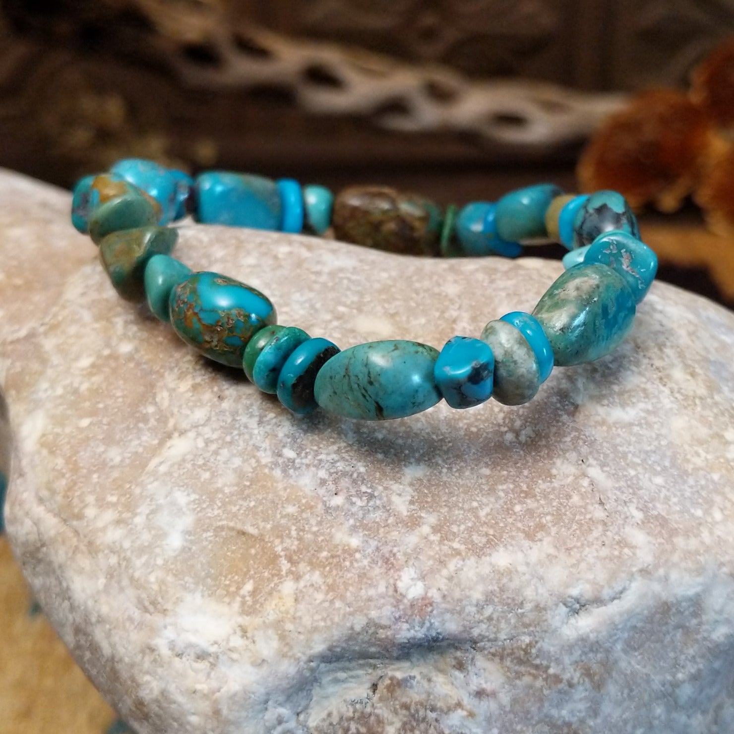 Bracelet with turquoise beaded along the elastic band.