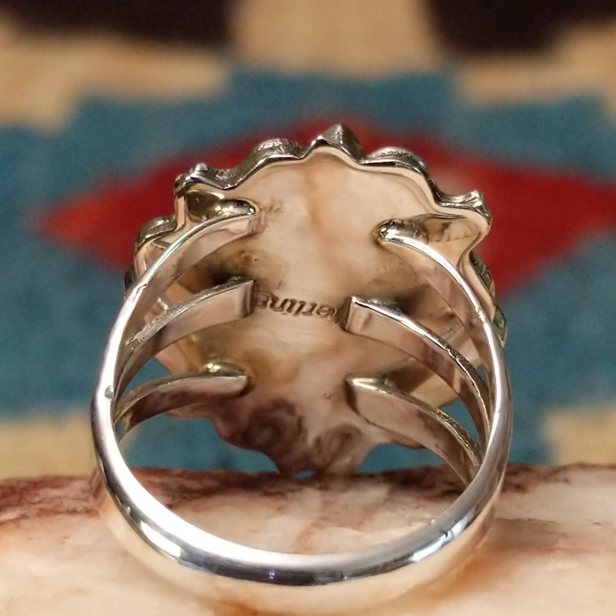 Navajo turquoise bear paw shadowbox ring, featuring a round blue turquoise stone set in a handcrafted sterling silver bear paw design with a dimensional shadowbox setting. Sterling Silver stamp.