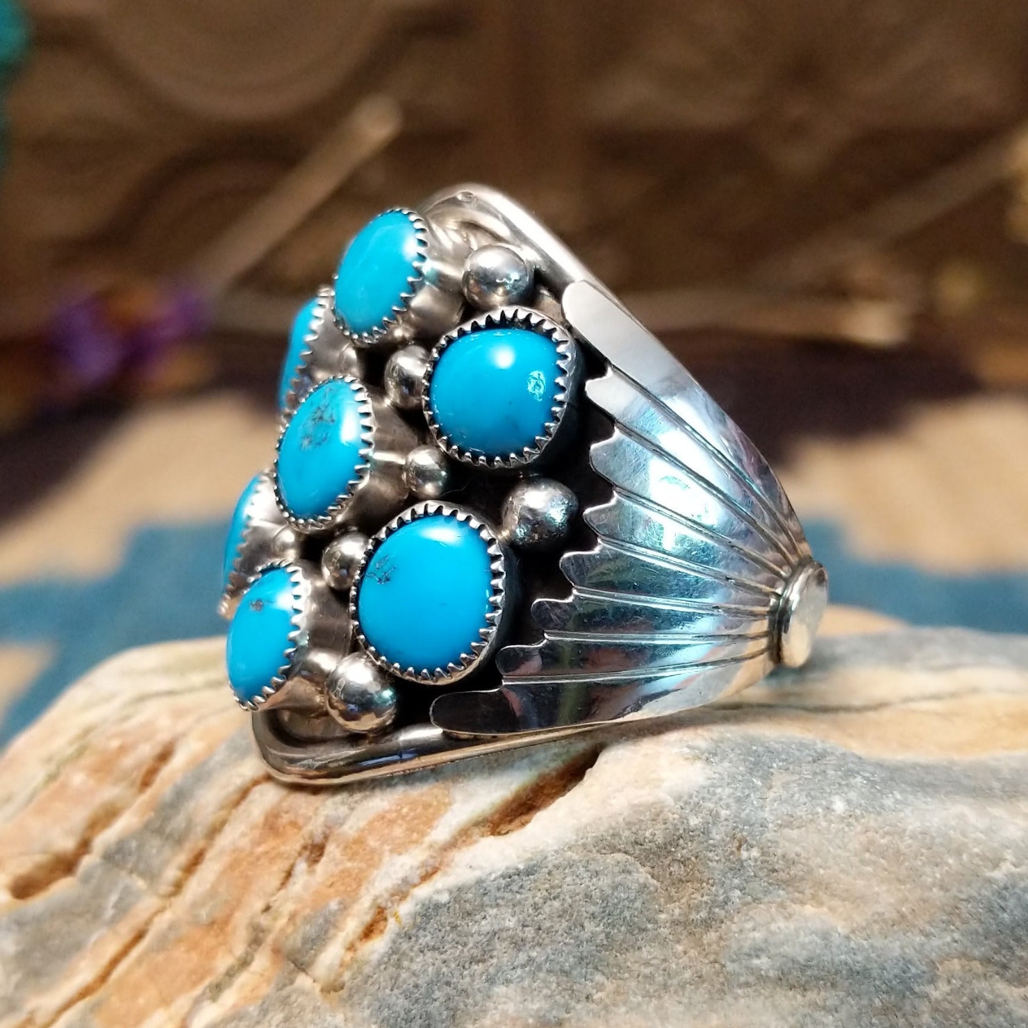 Sterling silver ring with turquoise set in clusters of notched bezels.