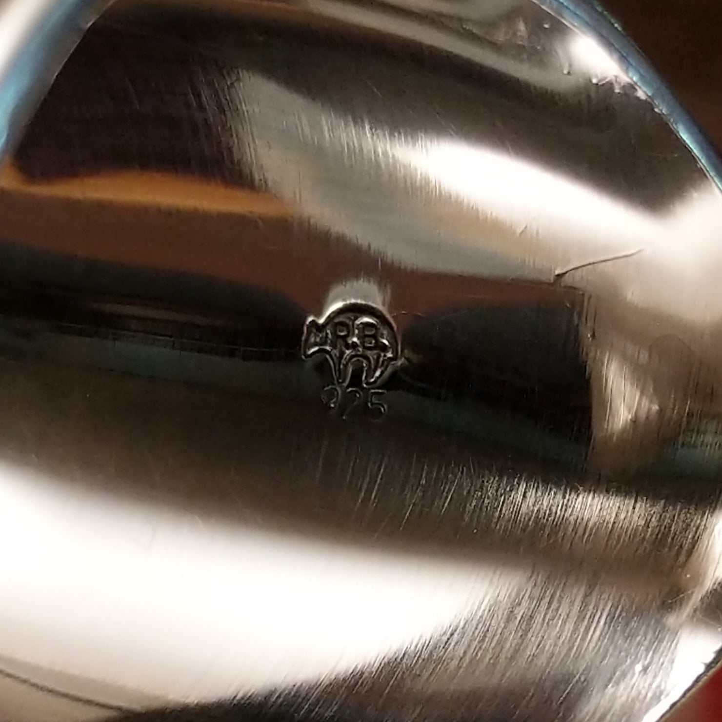 Close-up of the artisan's stamped signature.