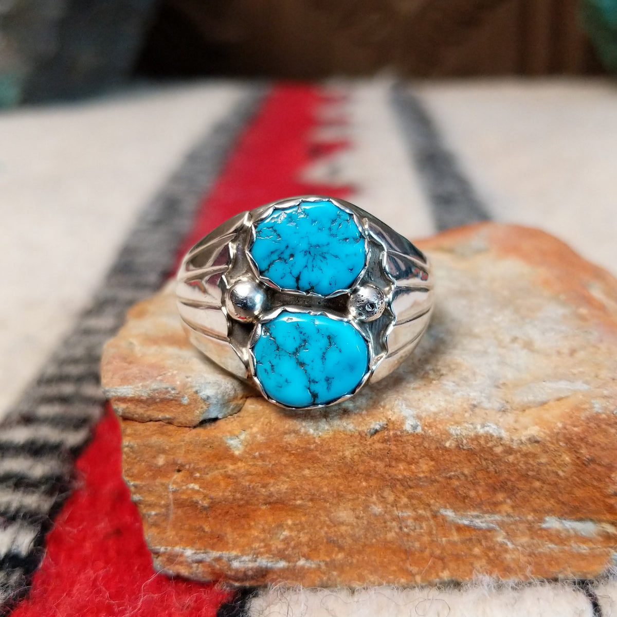 Navajo Turquoise Duo Ring by S. featuring two bright blue turquoise stones with dark matrix, silver bead accents, and a wide detailed silver band.