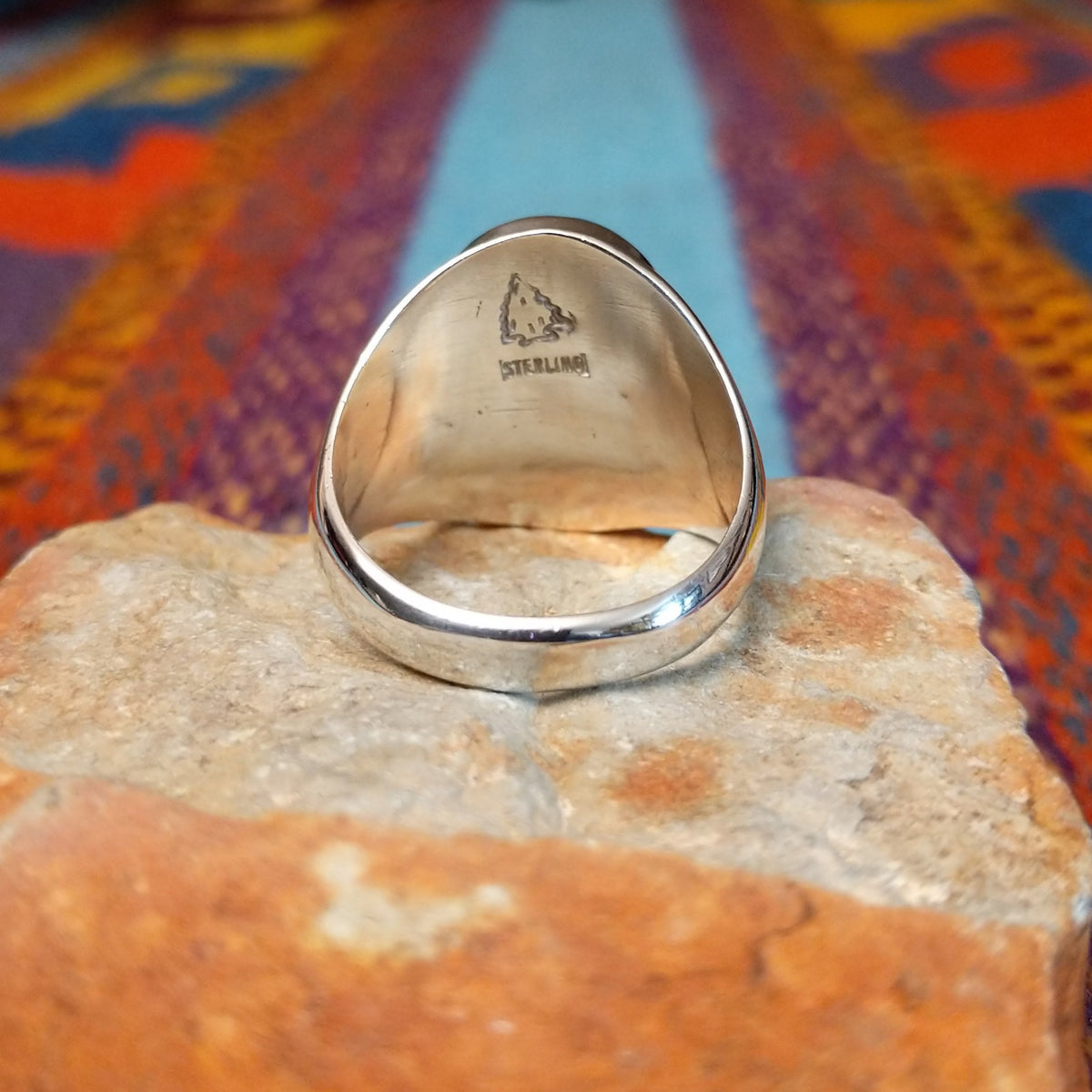 Navajo Turquoise Mosaic Ring featuring an oval face filled with geometric turquoise pieces in blue, aqua, sage, and green tones, set in a wide polished silver band; underside view.