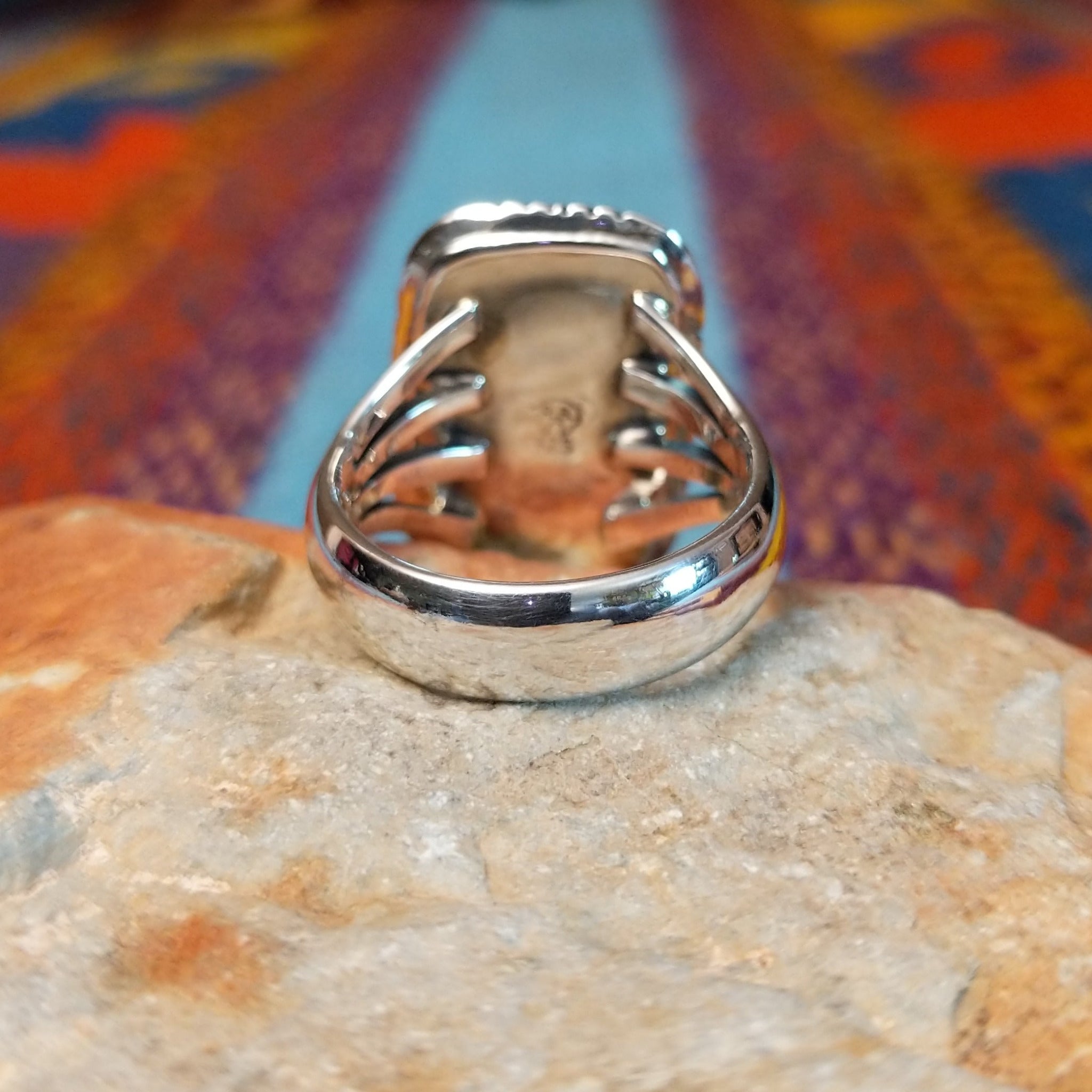 Navajo Turquoise Rectangle Ring featuring a large rectangular turquoise stone set in Sterling Silver with bold geometric stamped detailing and a split-shank band; underside view.
