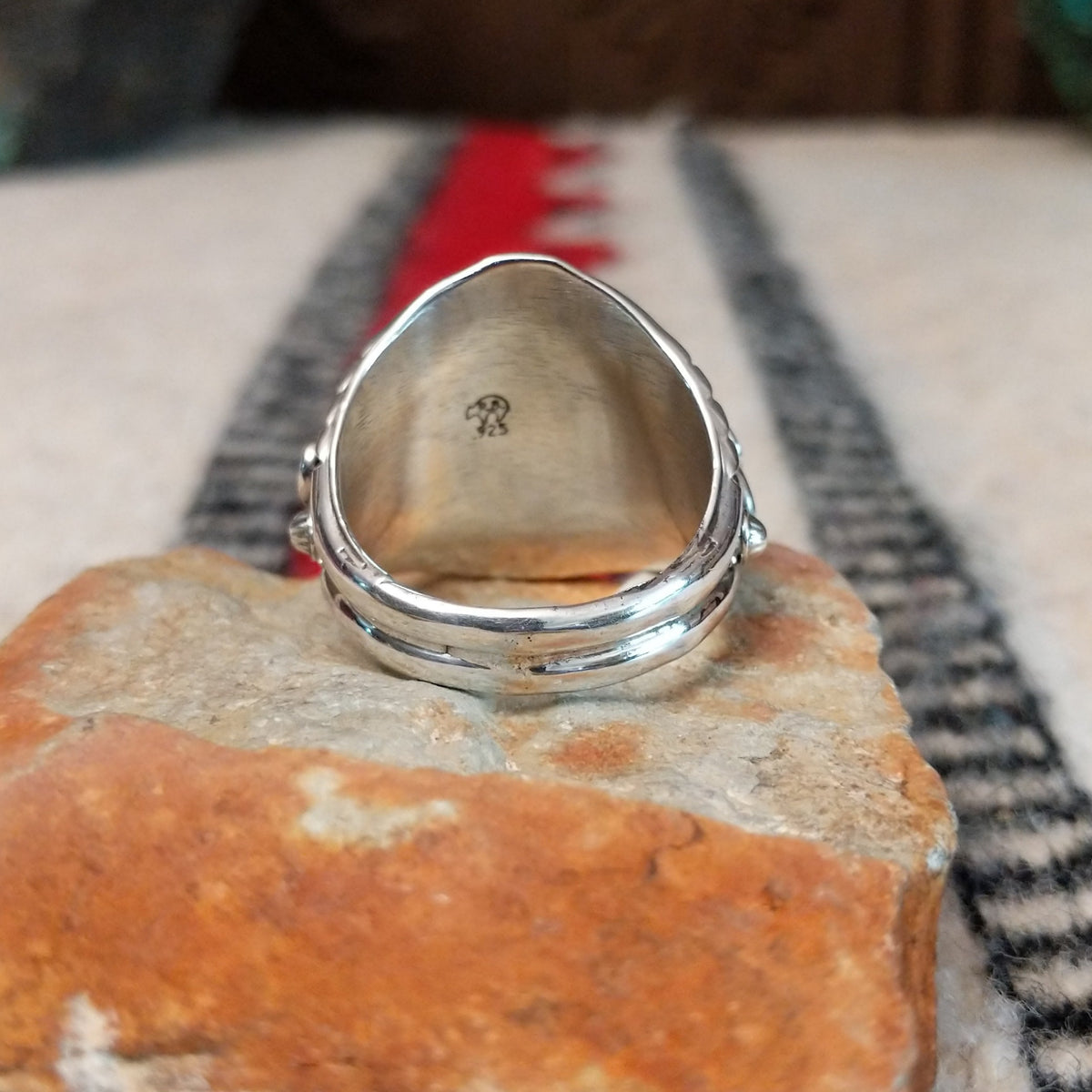 Navajo turquoise ring with layered silver leaves, drops, and wirework.