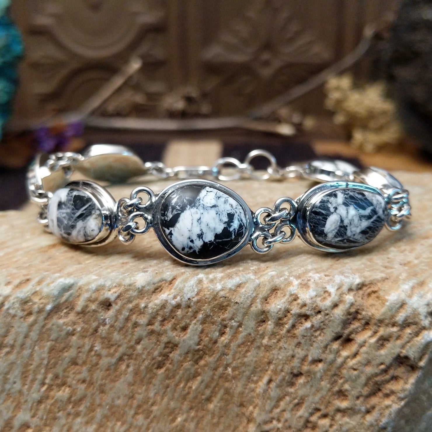 Sterling silver link bracelet with white buffalo set in oval bezels.