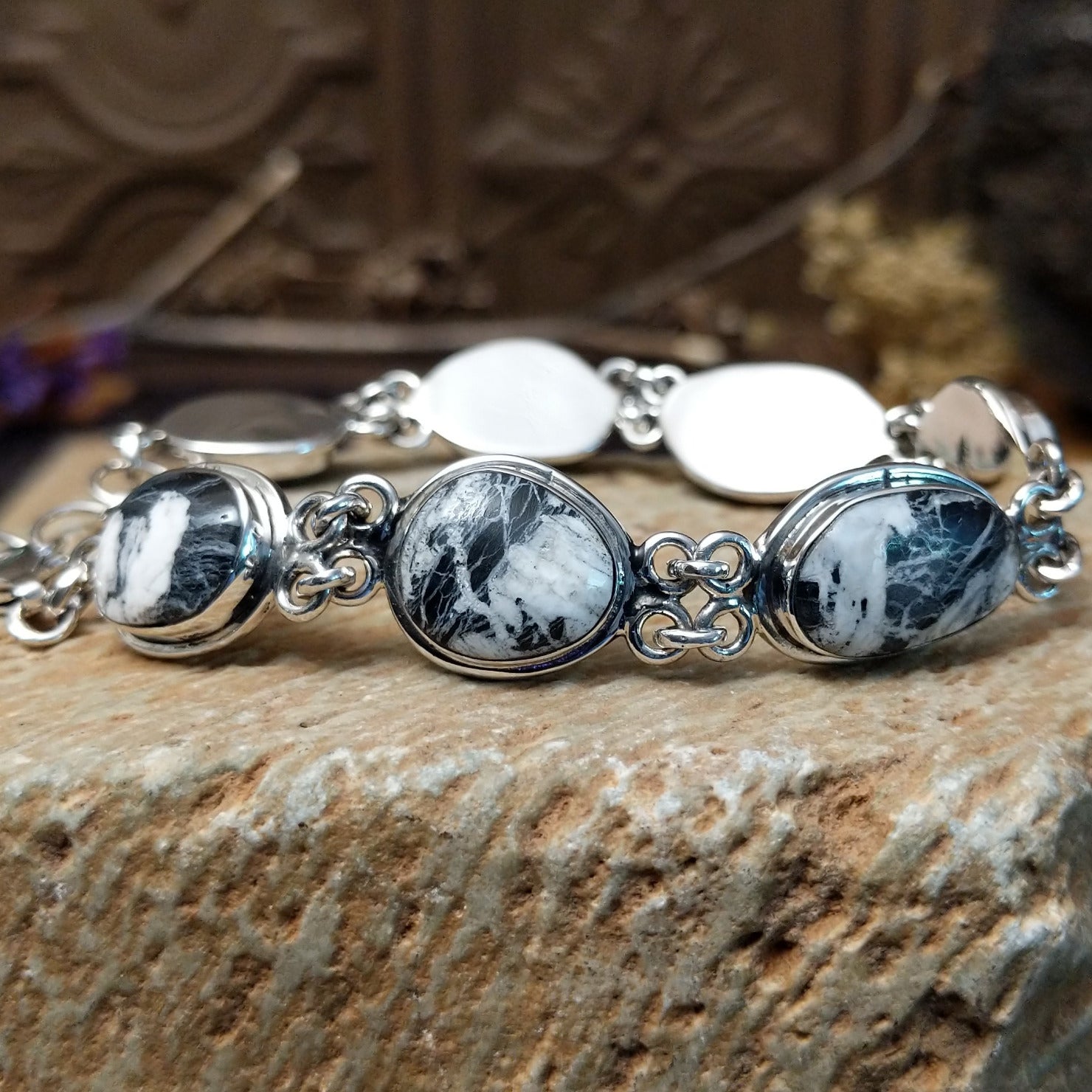Sterling silver link bracelet with white buffalo set in oval bezels.
