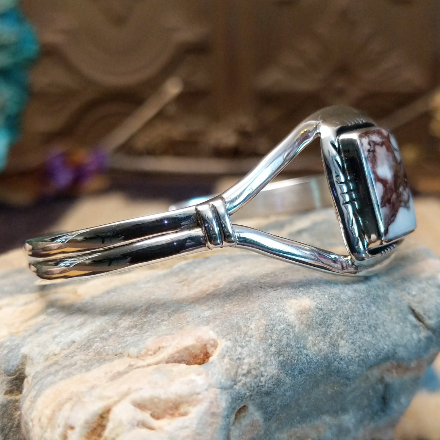 Sterling silver cuff with wild horse stone set in a rectangular bezel, framed by incised lining and a delicate band.