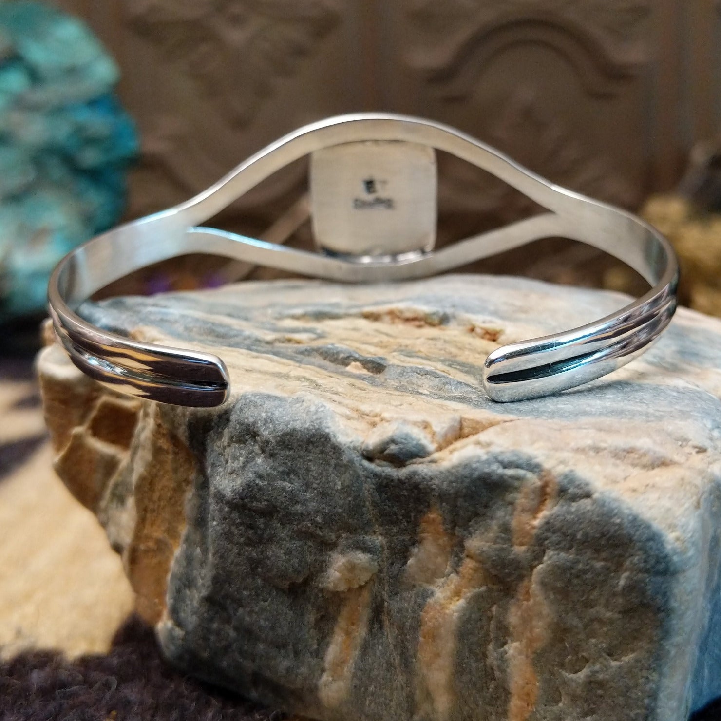Sterling silver cuff with wild horse stone set in a rectangular bezel, framed by incised lining and a delicate band.